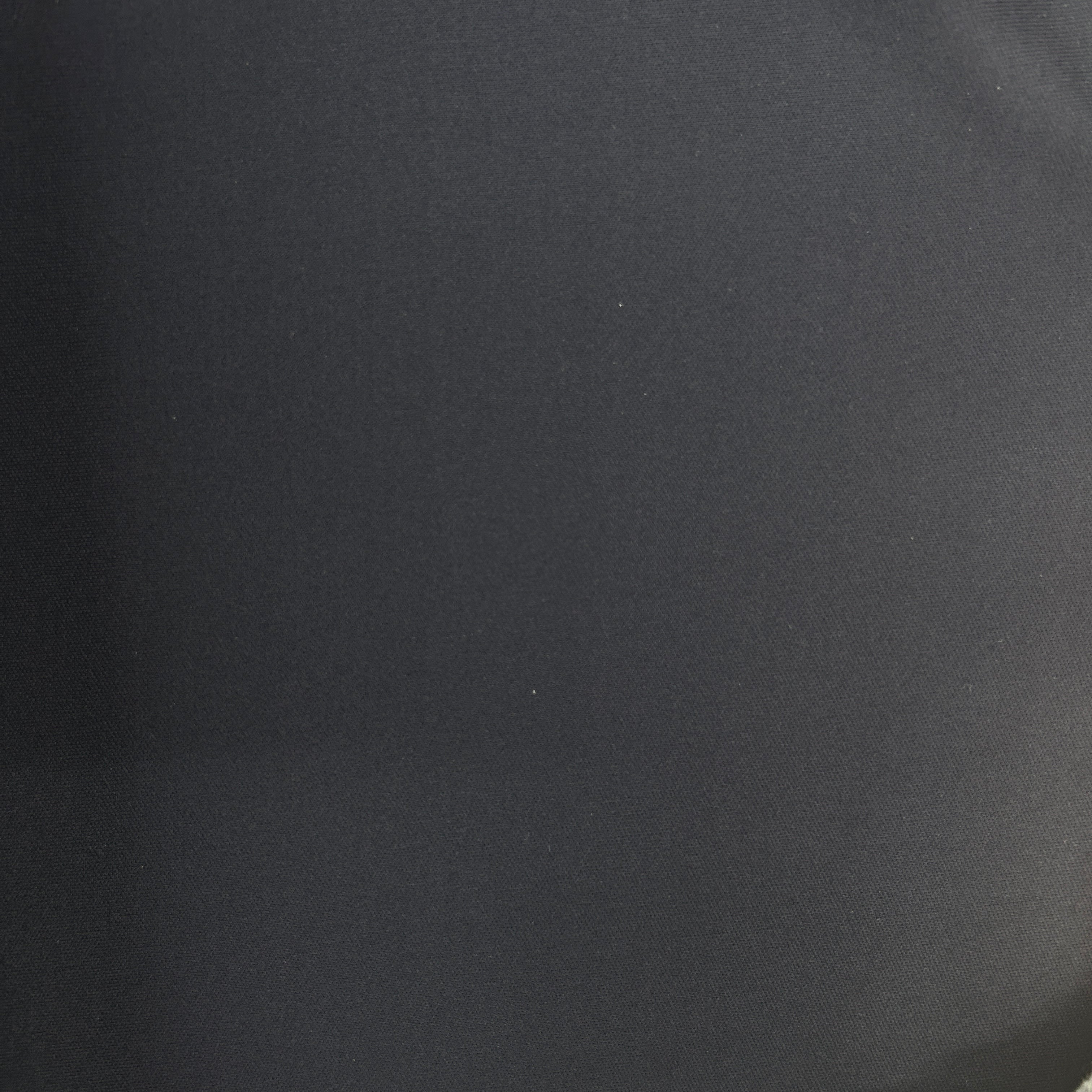 A close-up of a dark charcoal gray fabric texture with a subtle sheen.
