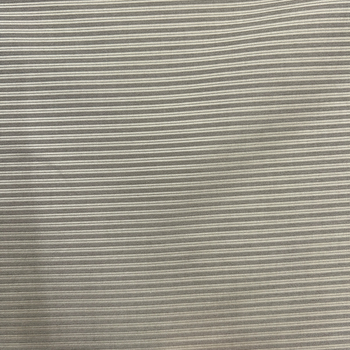 A close-up of a striped fabric with thin horizontal stripes in beige and gray.