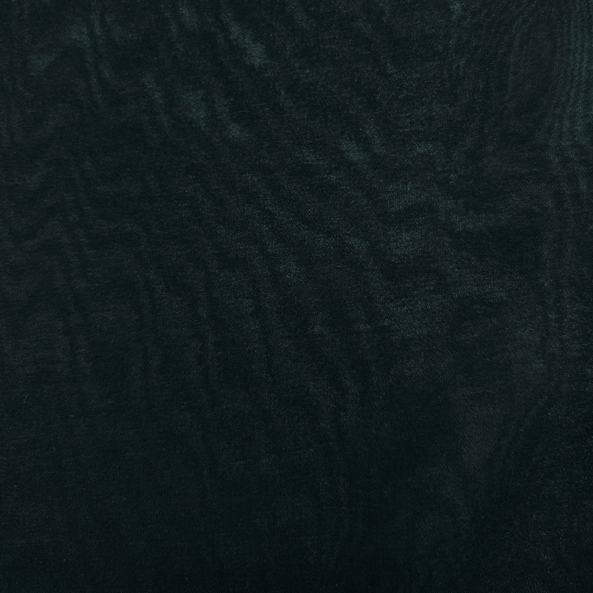 A close-up of a dark textured material with a subtle wavy pattern, appearing in deep black or very dark charcoal tones.