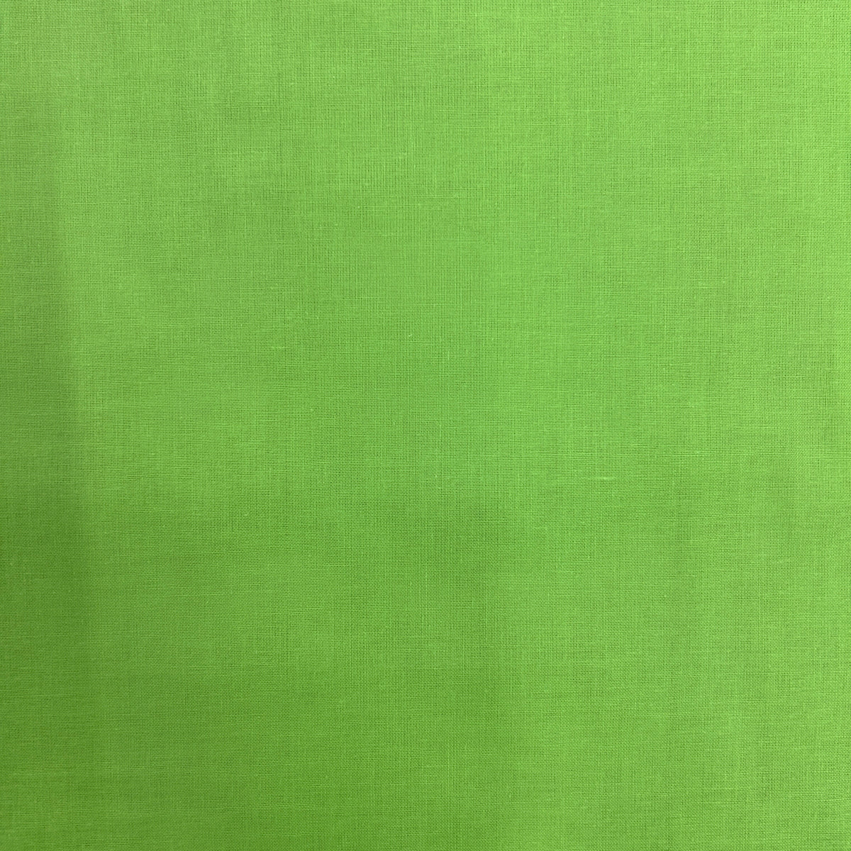 A close-up of a bright lime green textured fabric, showing a fine woven pattern.