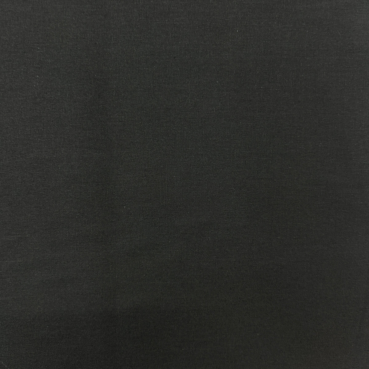 A close-up of a solid black textured fabric surface.