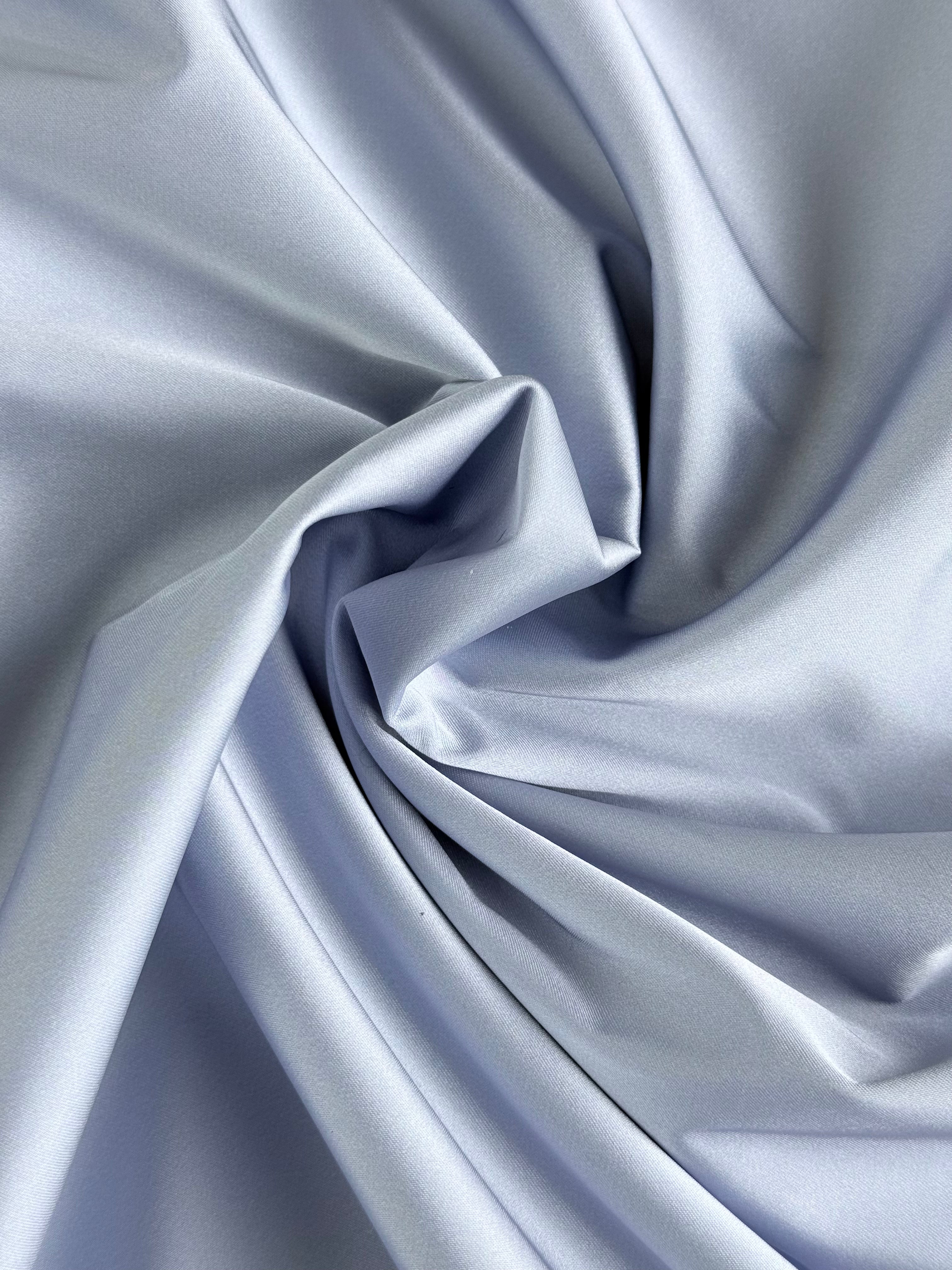 Lilac bonded satin polyester fabric with a smooth, lustrous finish and elegant draped folds.