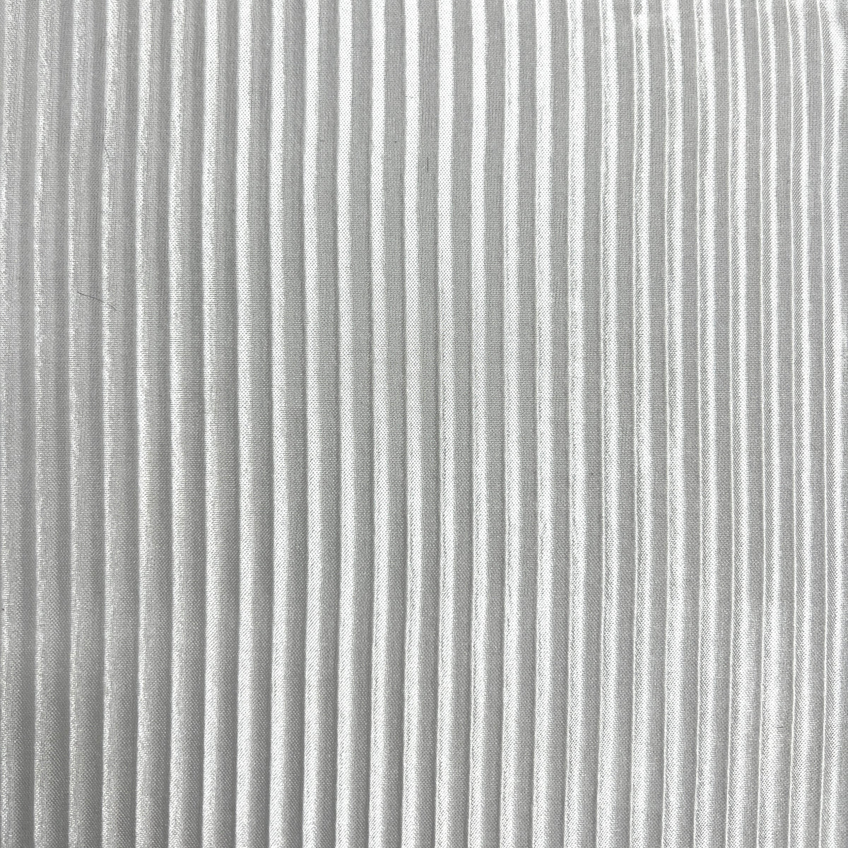 A close-up of a light gray pleated fabric texture with vertical folds.