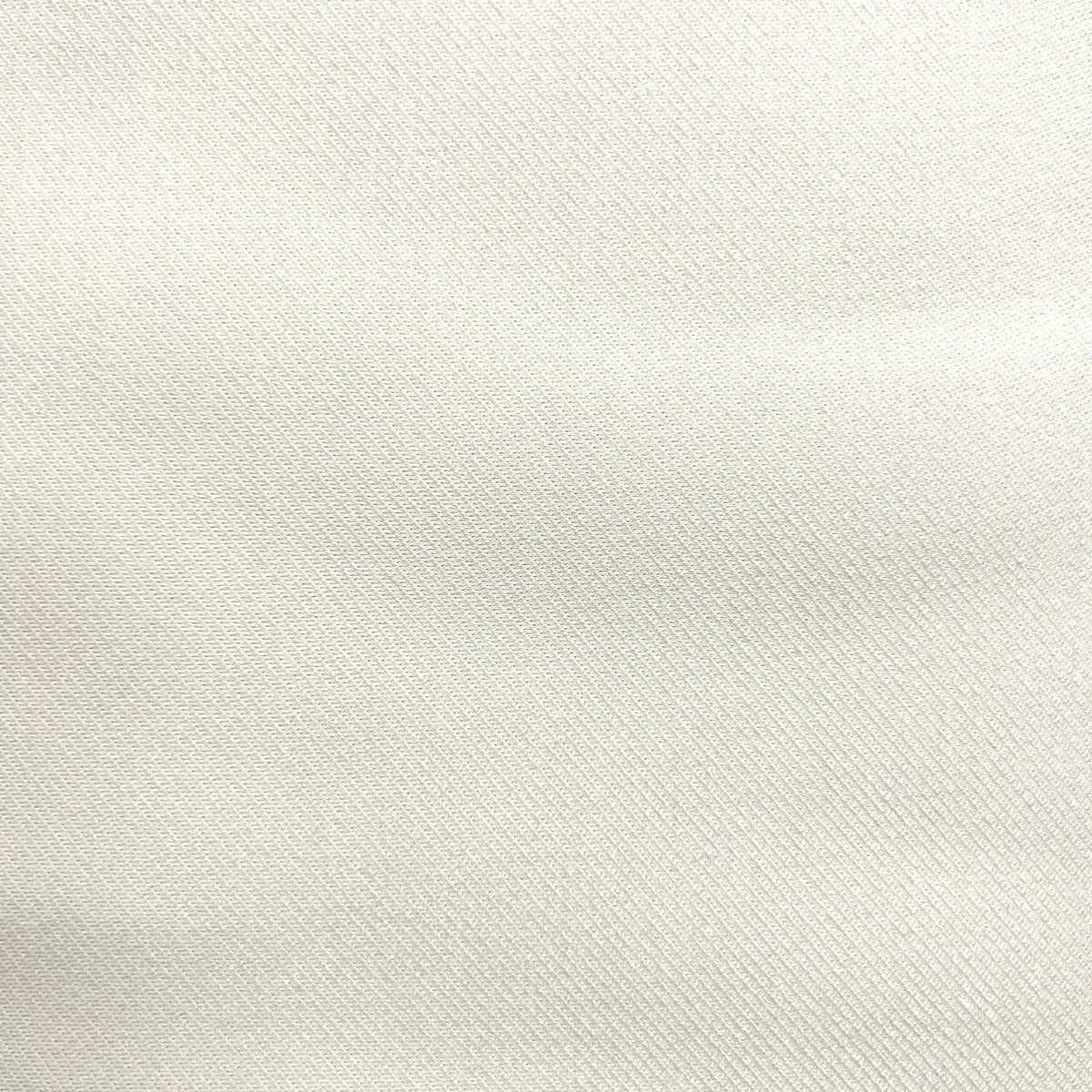 A close-up of a light cream or off-white textured fabric surface with subtle folds and a fine woven texture.