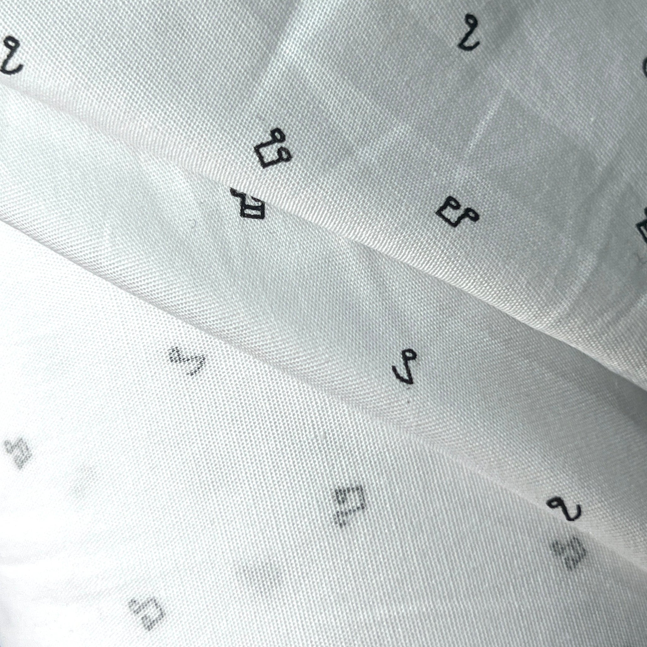 White fabric with black geometric patterns