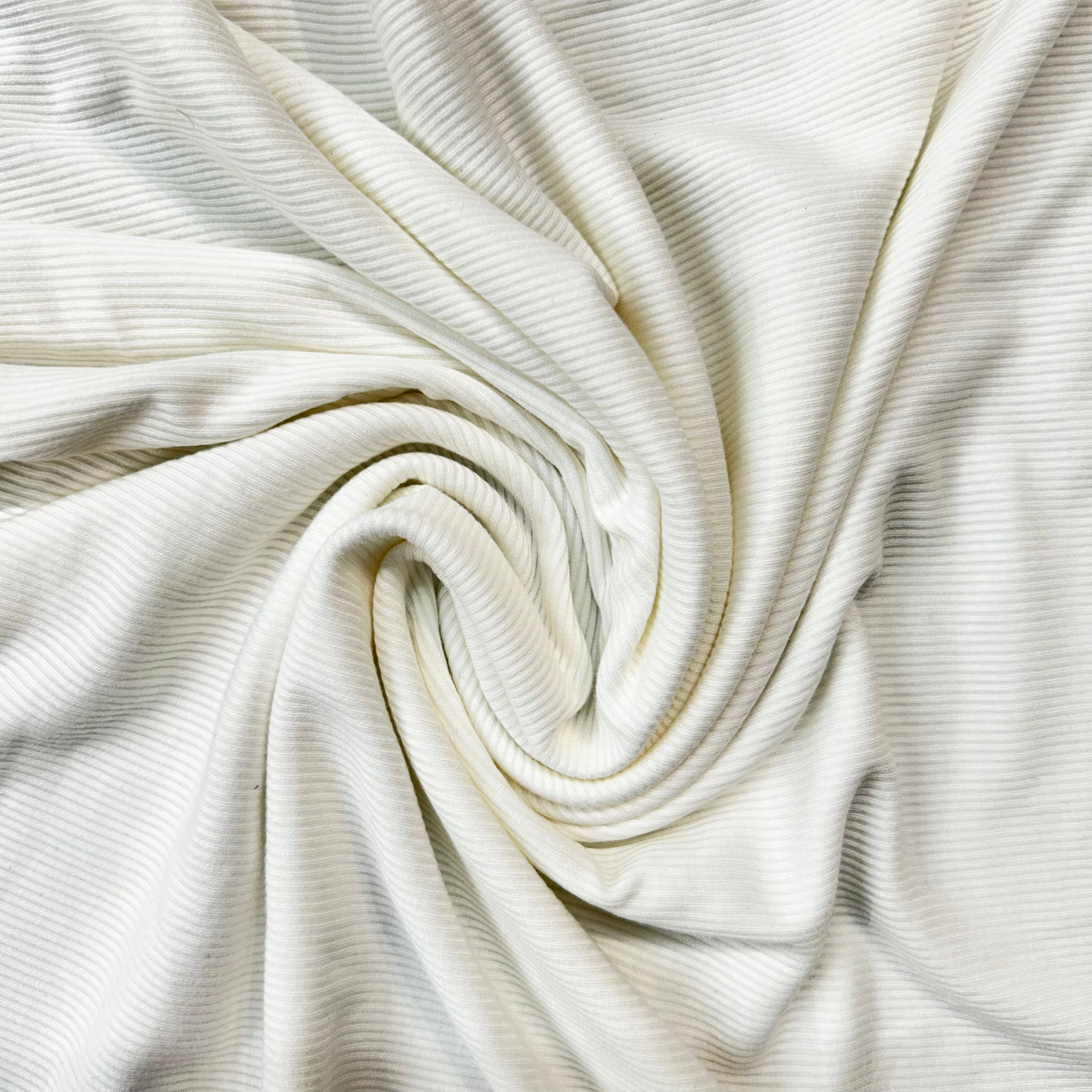 Close-up of white ribbed fabric with a swirl pattern