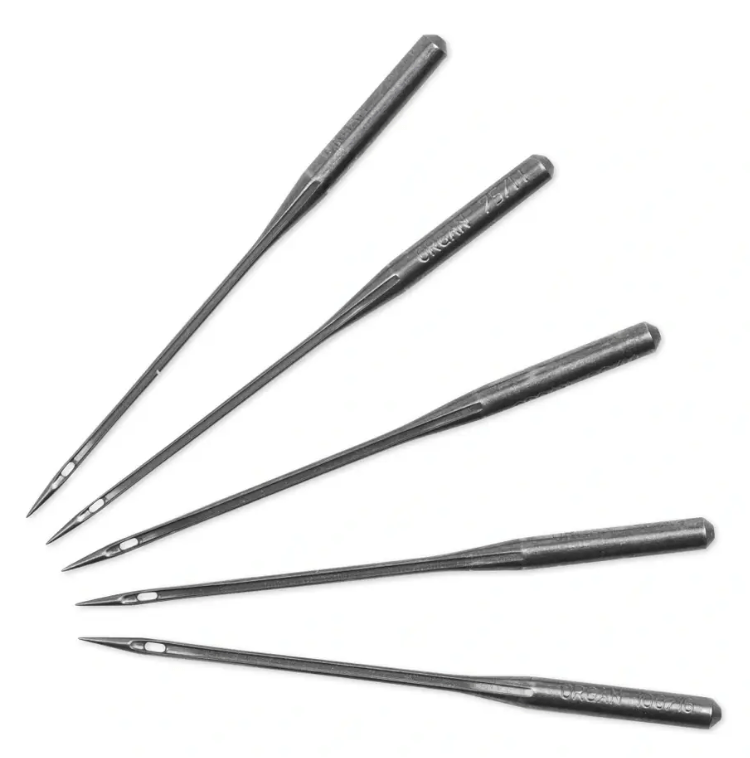 Five steel sewing machine needles of varying sizes with large eyes.