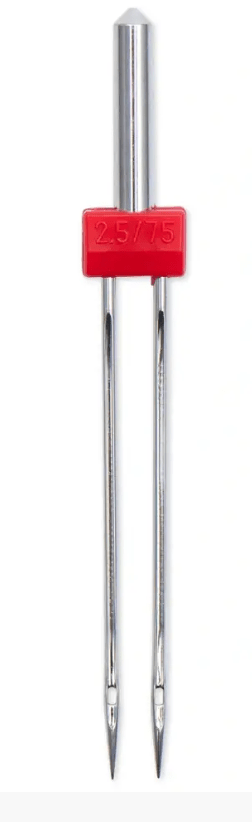 Silver-colored twin sewing machine needles with a red 2.5/75 marking.