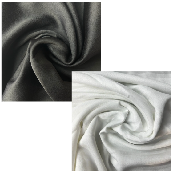 Two swatches of fabric, one dark gray and one white, on a white background.