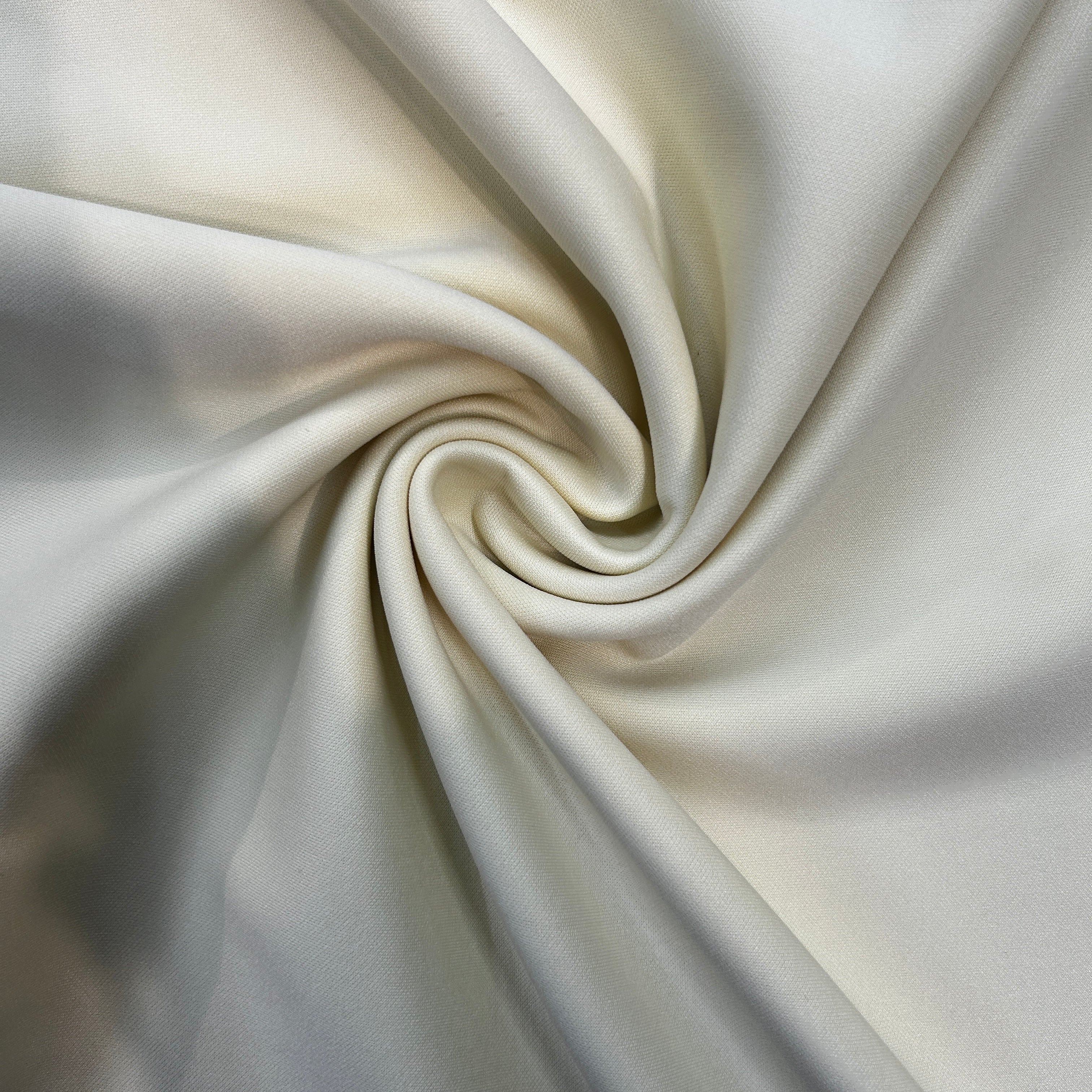 Close-up of cream-colored fabric with a swirl pattern