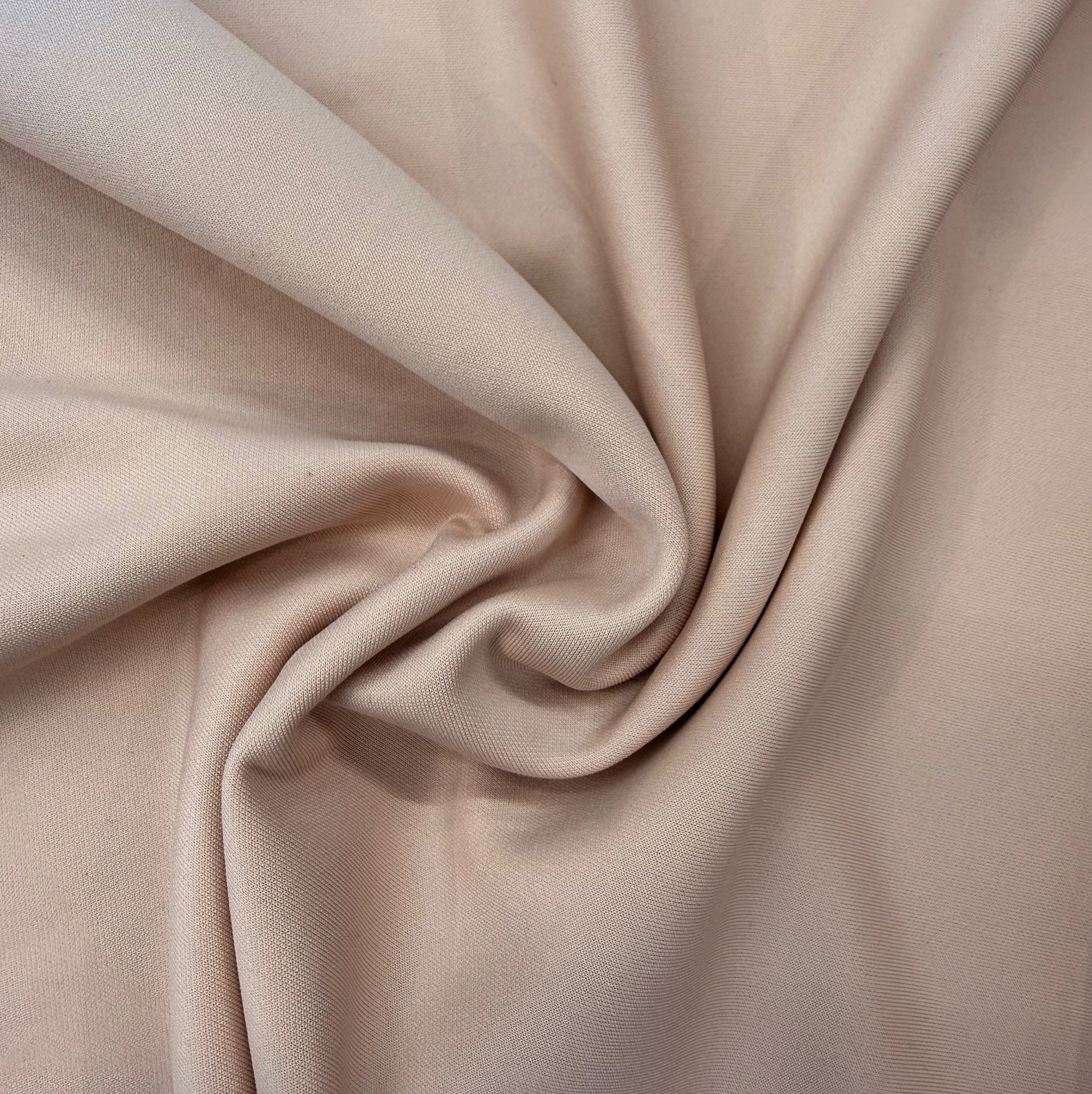 Close-up of beige fabric with folds