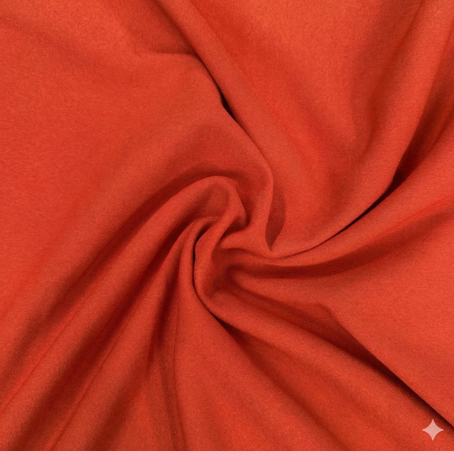 Close-up of orange fabric with a swirl pattern