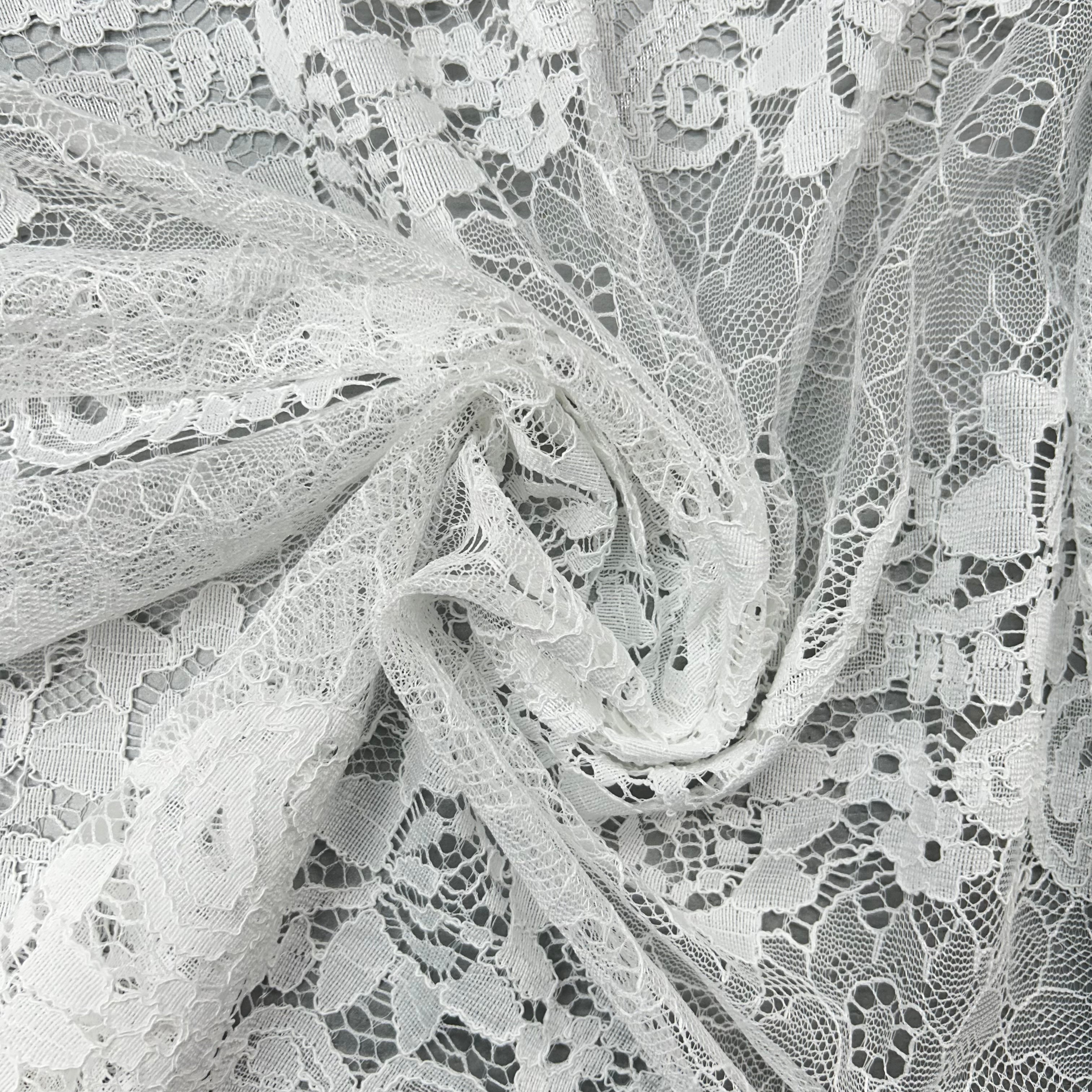 Close-up of white lace fabric with intricate patterns