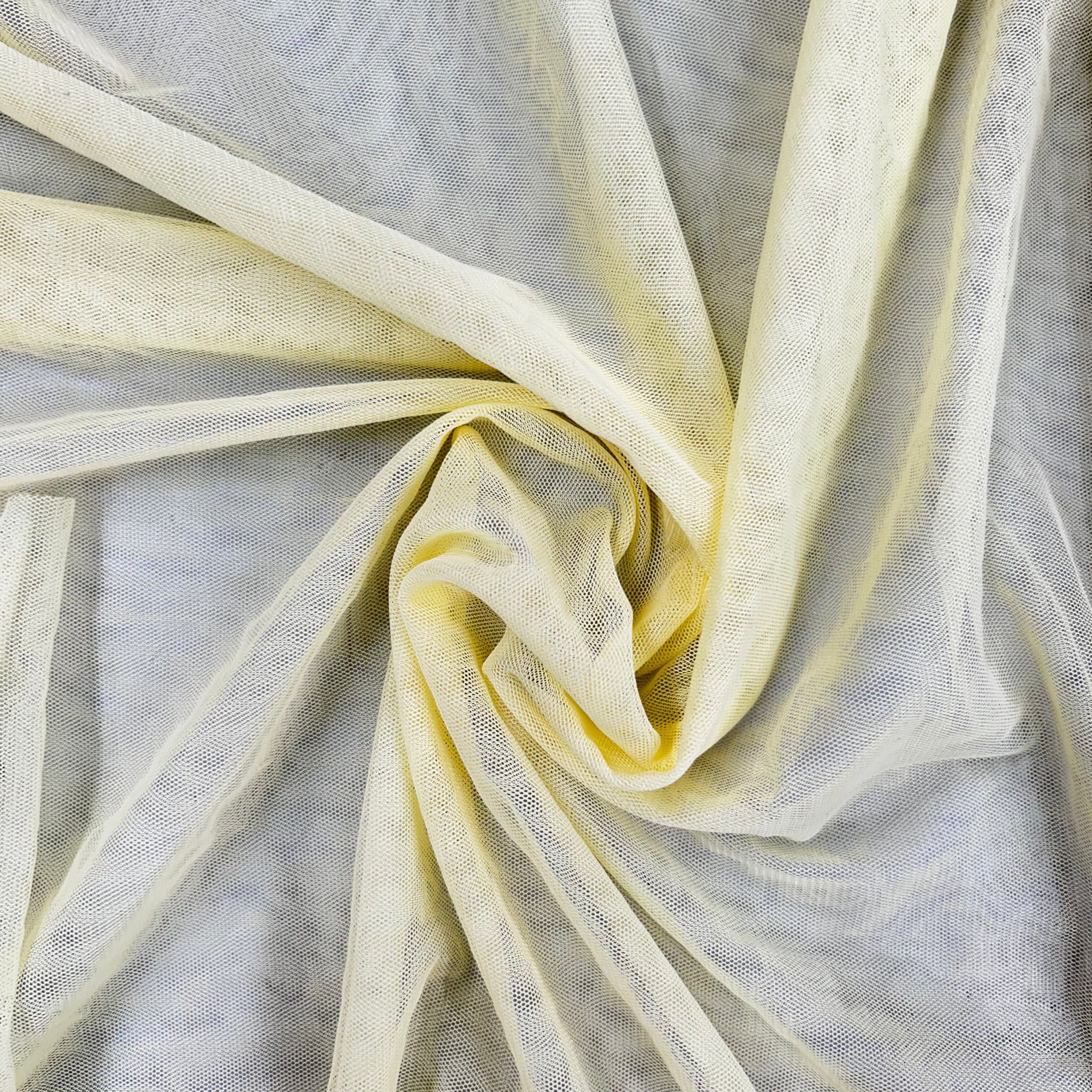 Close-up of sheer yellow fabric on a textured gray background