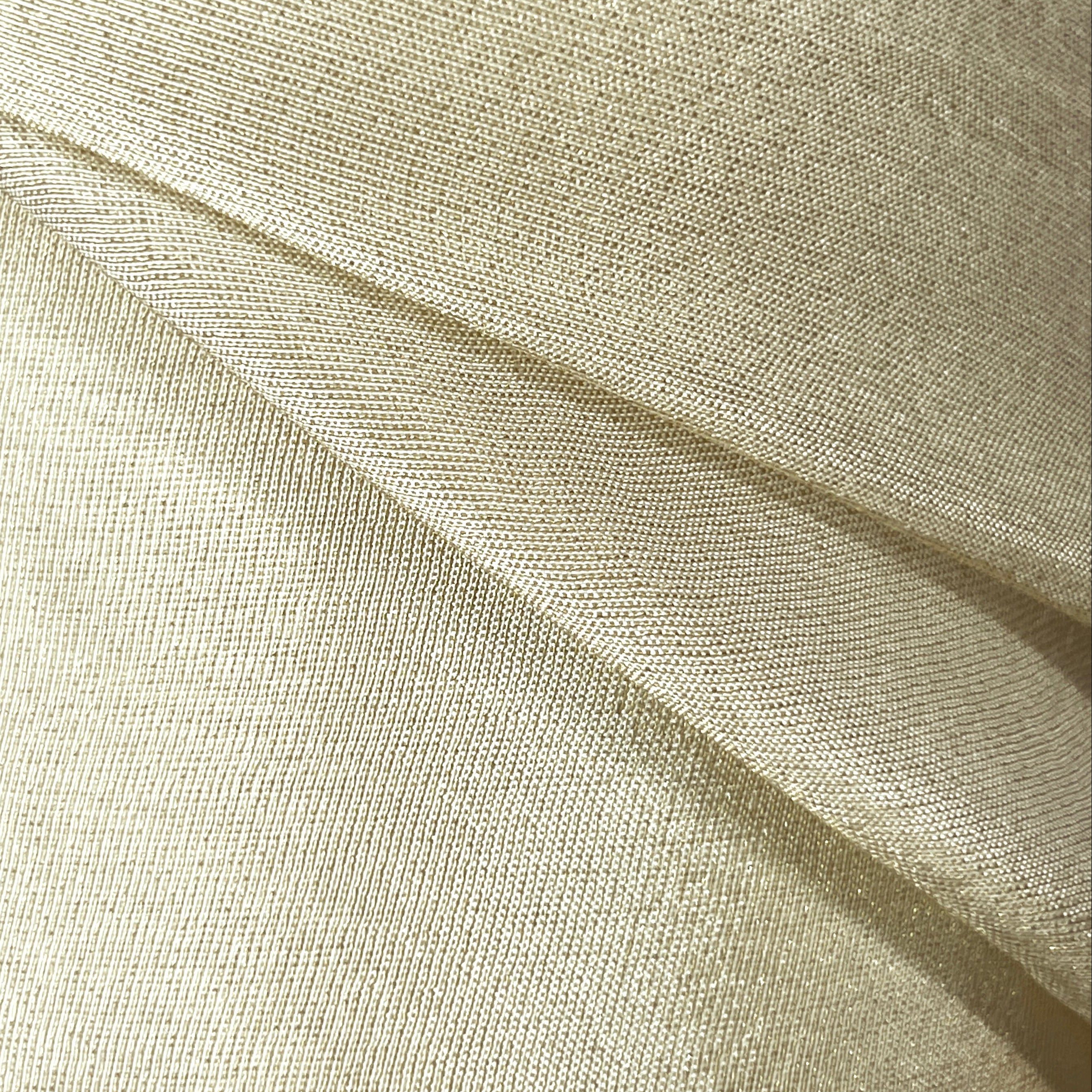 Close-up of beige fabric with a textured pattern