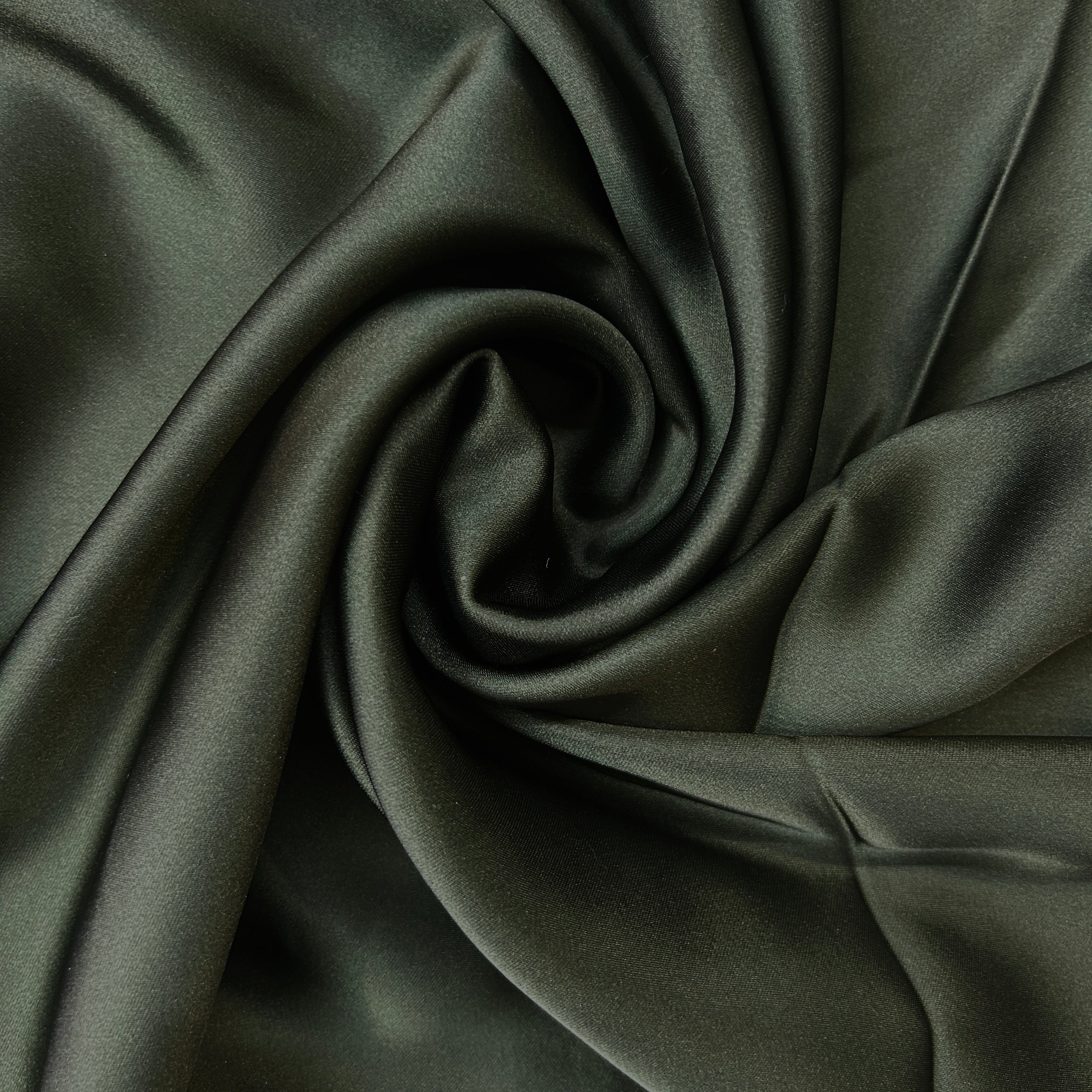 Close-up of dark green fabric with folds
