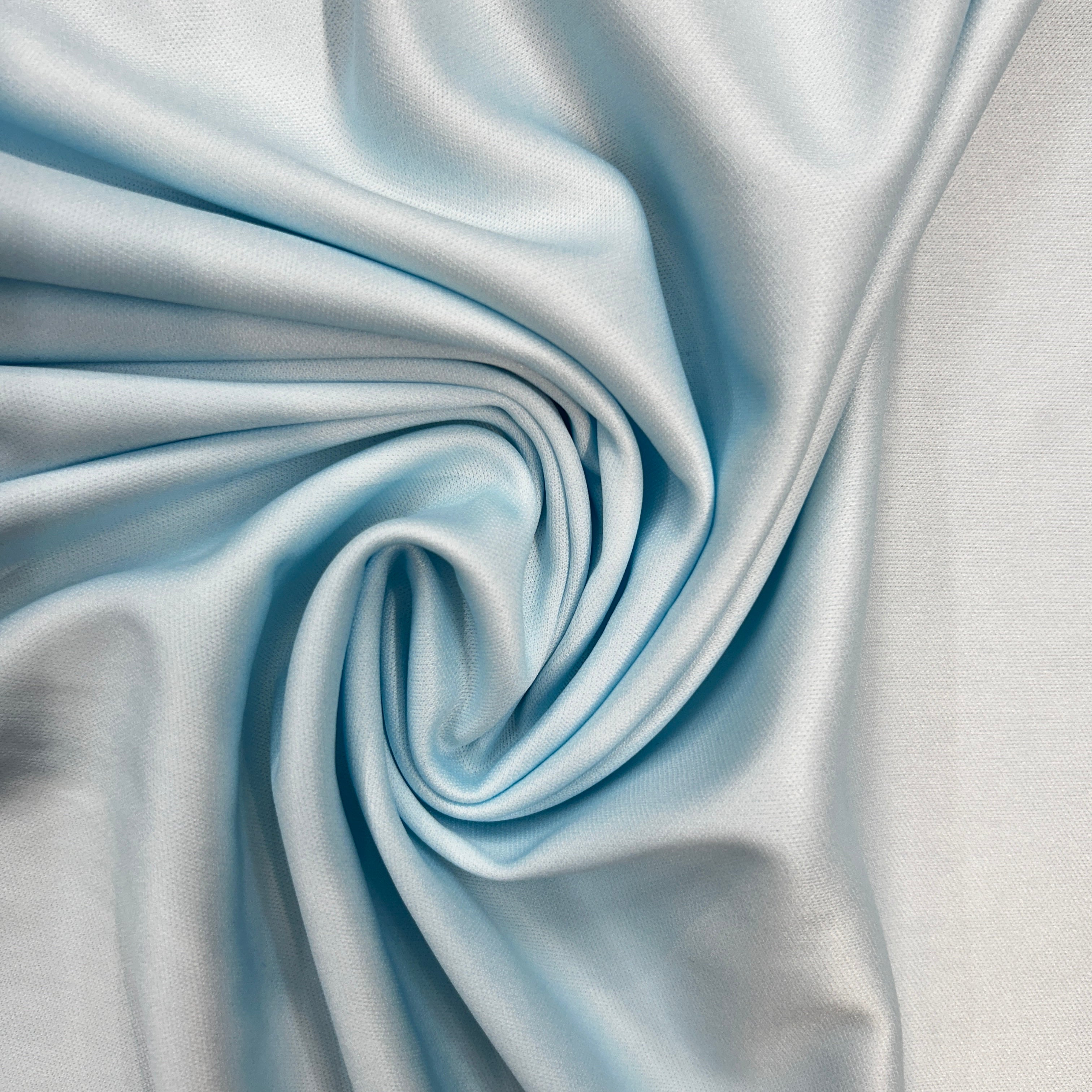 Close-up of light blue fabric with folds