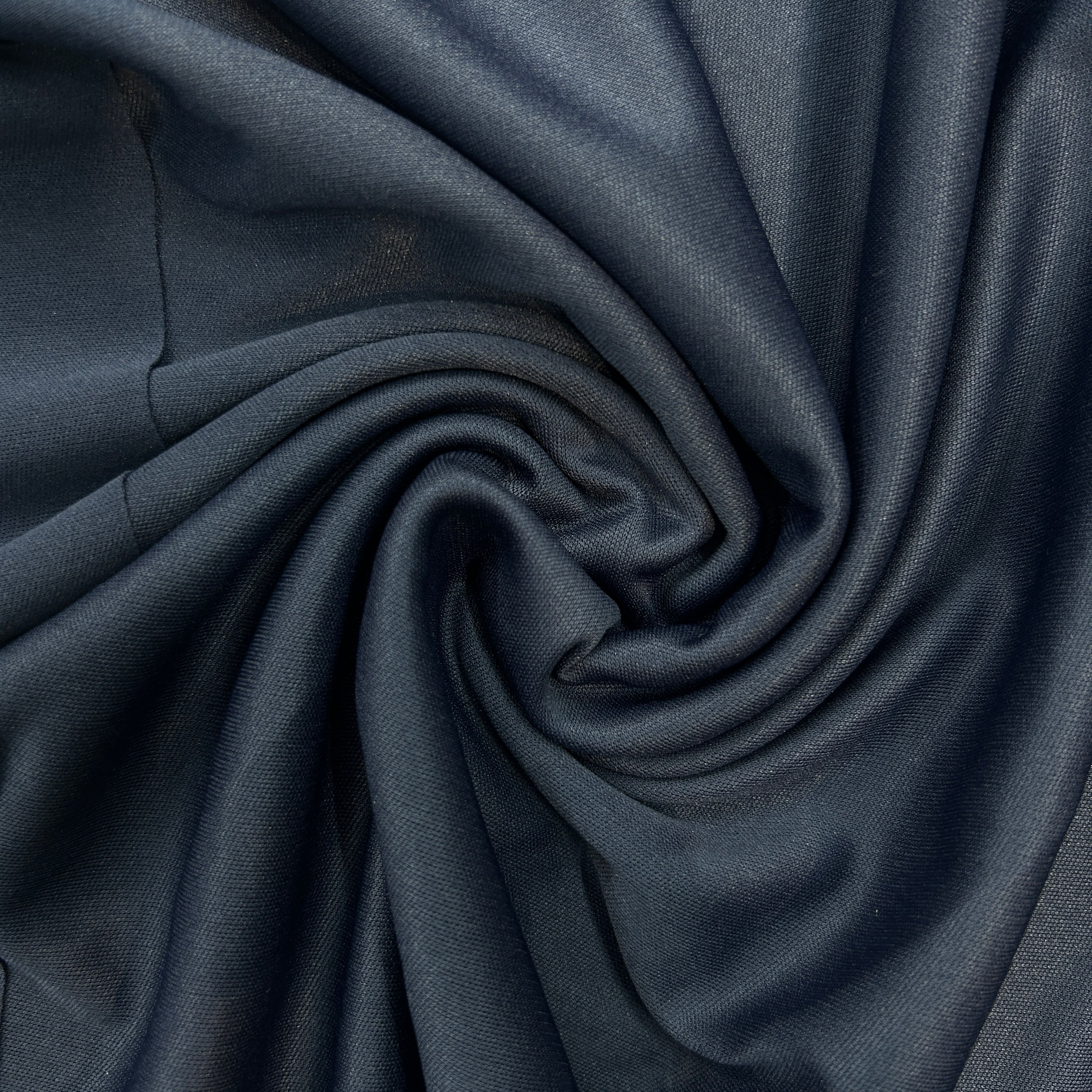 Close-up of dark blue fabric with folds