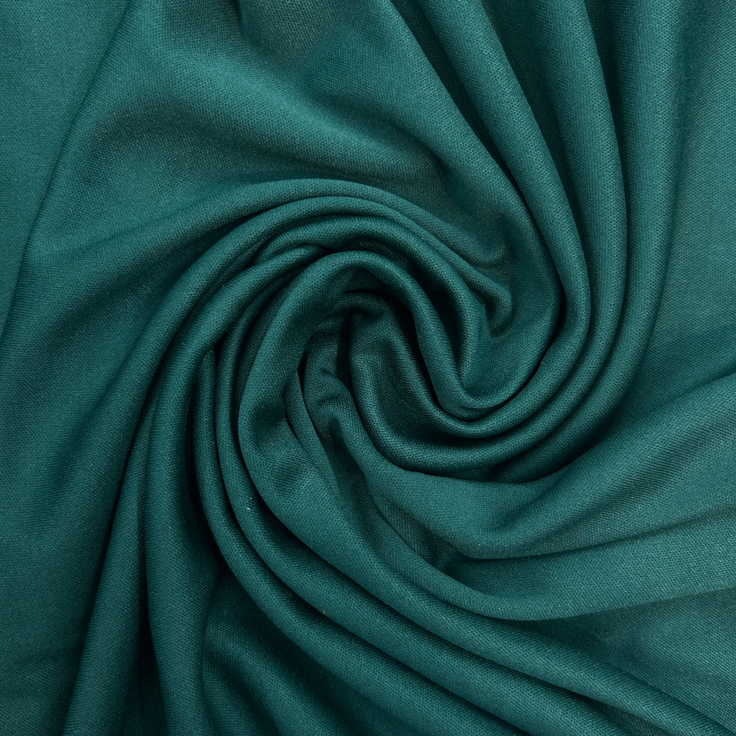 Close-up of teal fabric with a swirl pattern