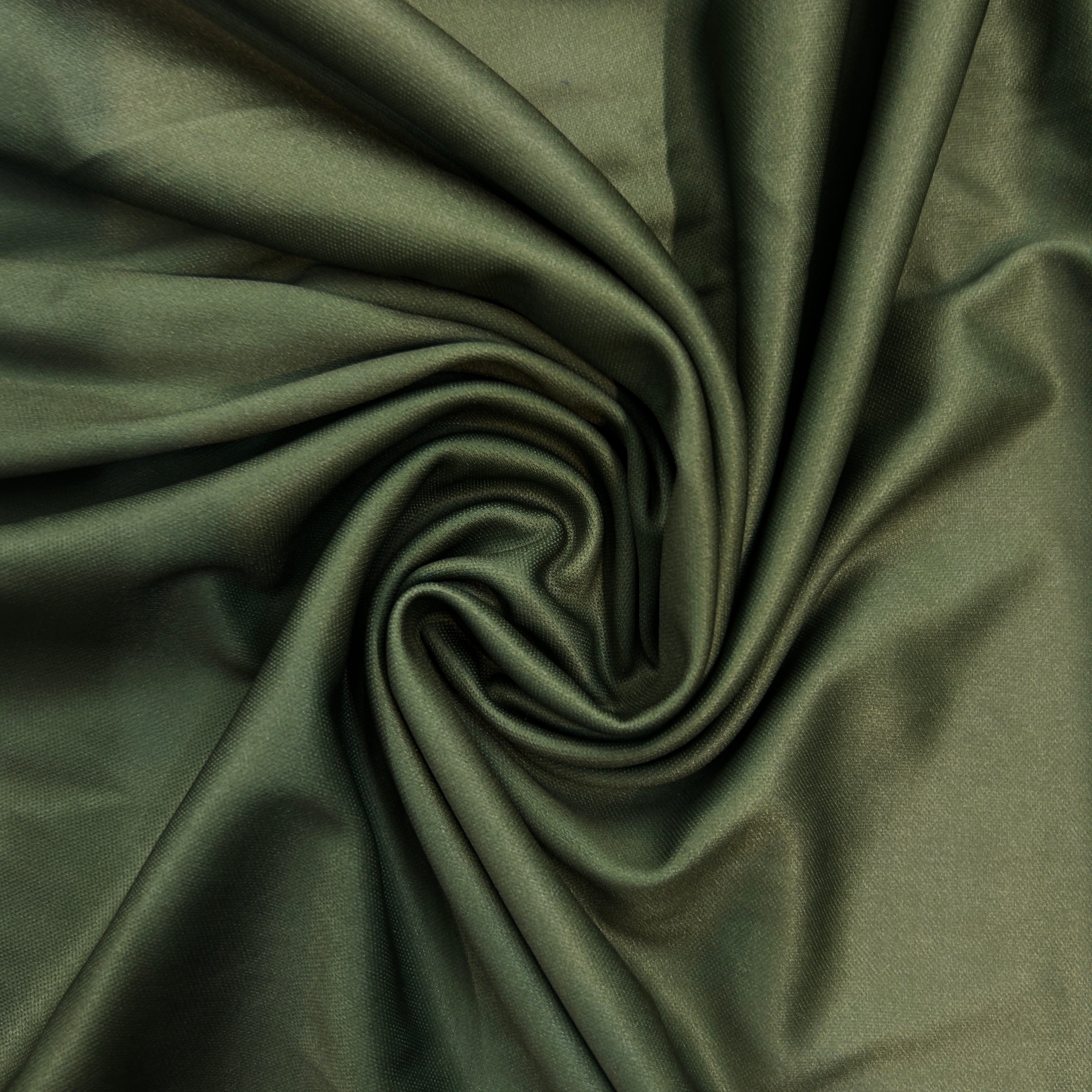 Close-up of dark green fabric with folds