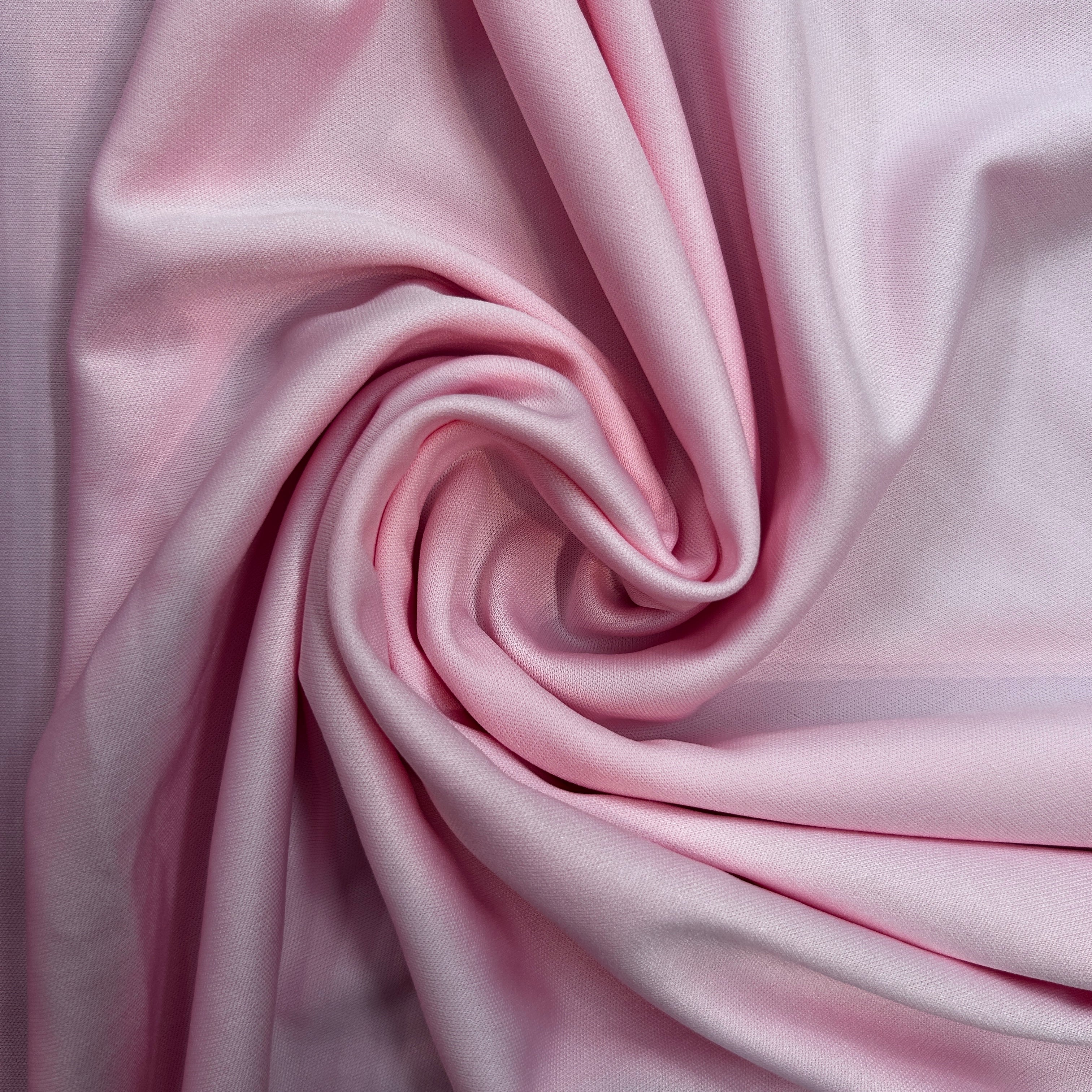 Close-up of pink fabric with a swirl pattern