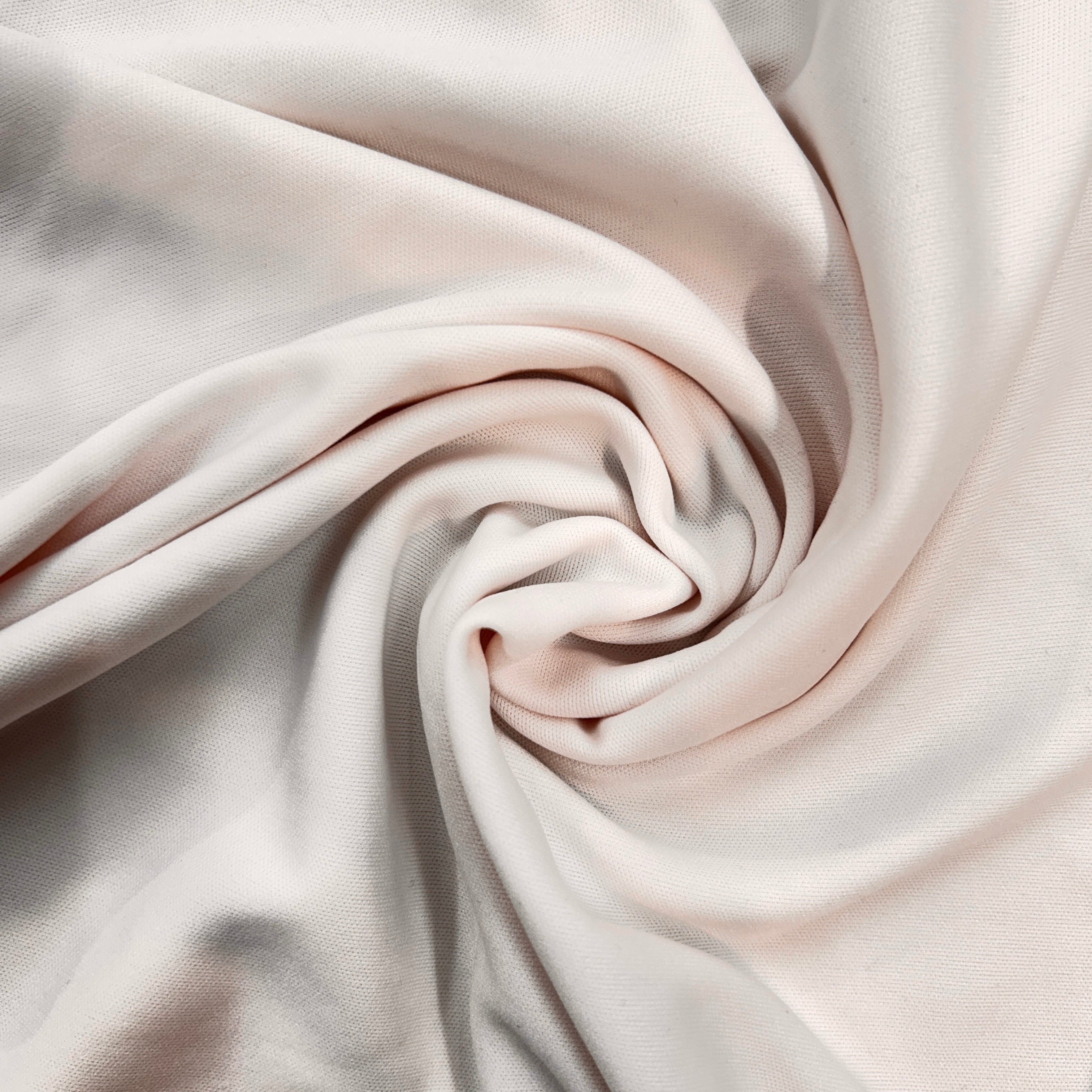 Close-up of beige fabric with a swirl pattern