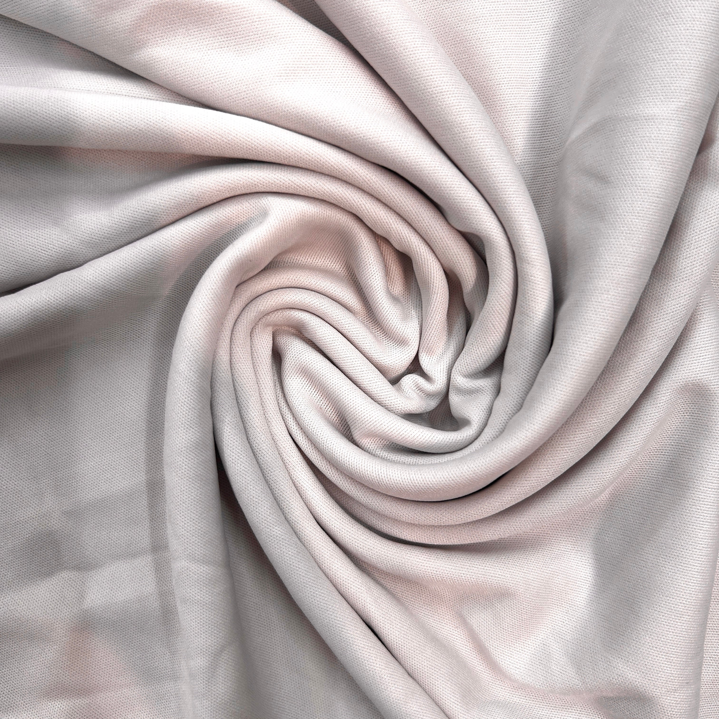 Close-up of light gray fabric with a swirling pattern