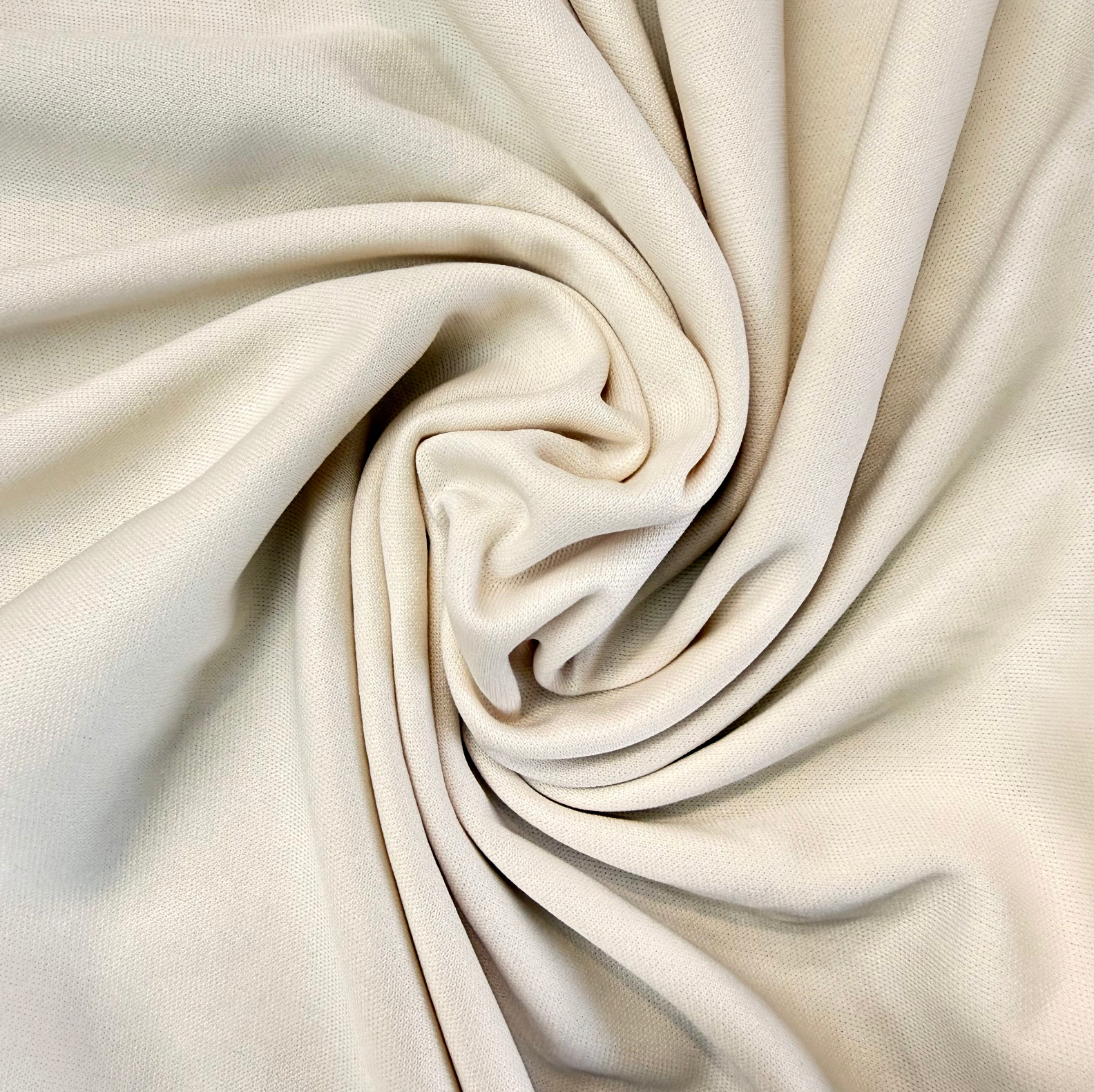 Close-up of beige fabric with folds