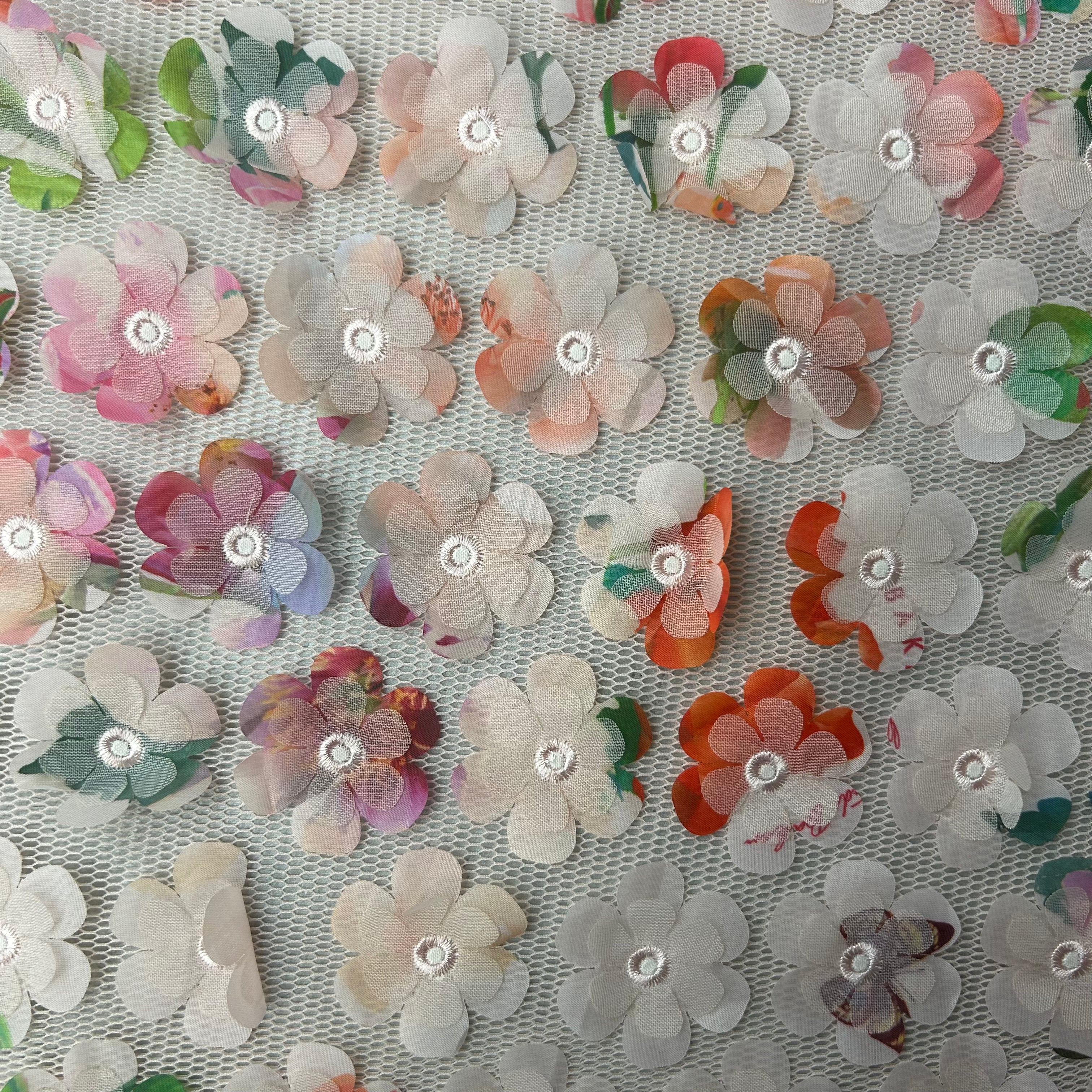 Decorative fabric with floral patterns and rhinestones on a mesh background