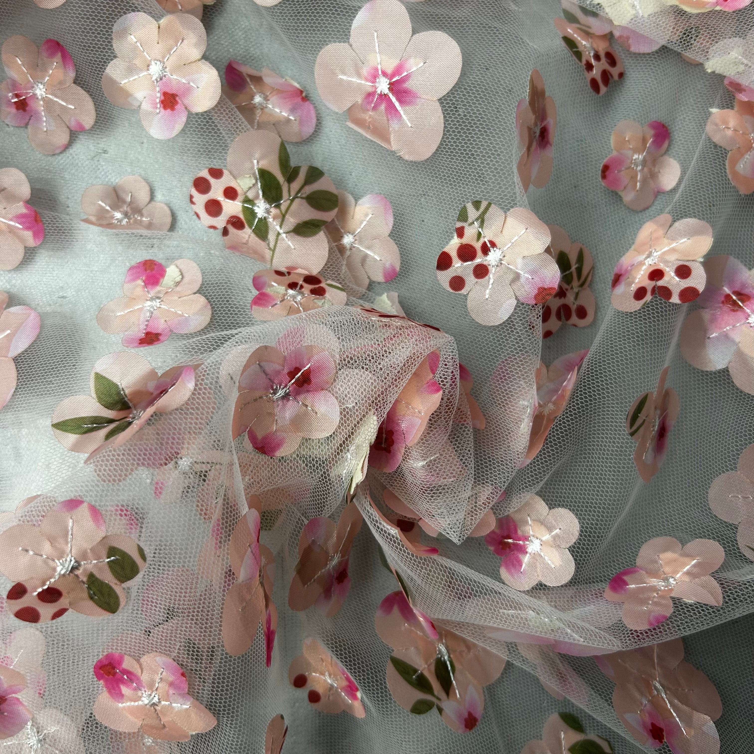 Floral fabric with pink and red flowers on a light background