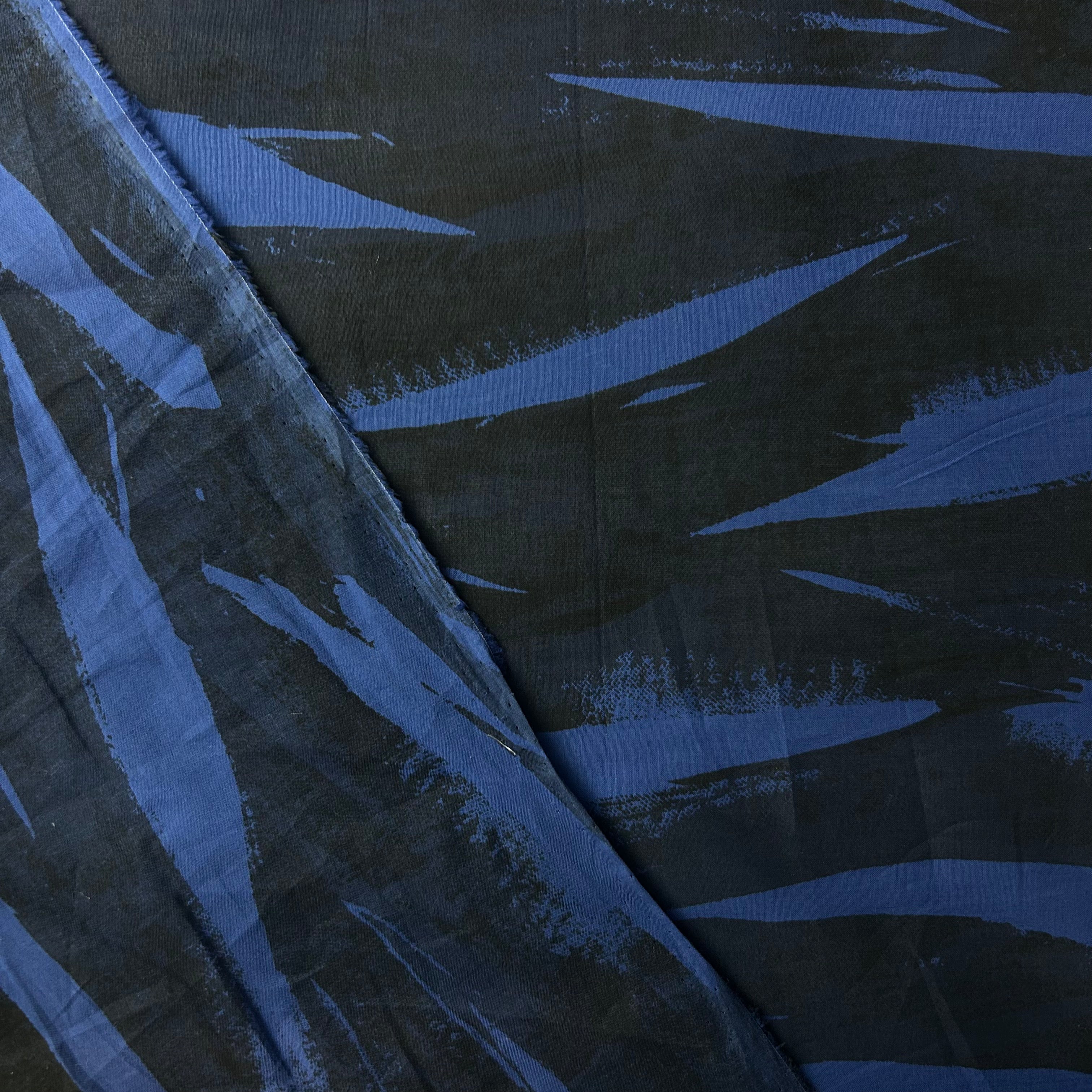 Close-up of blue and black fabric with abstract pattern