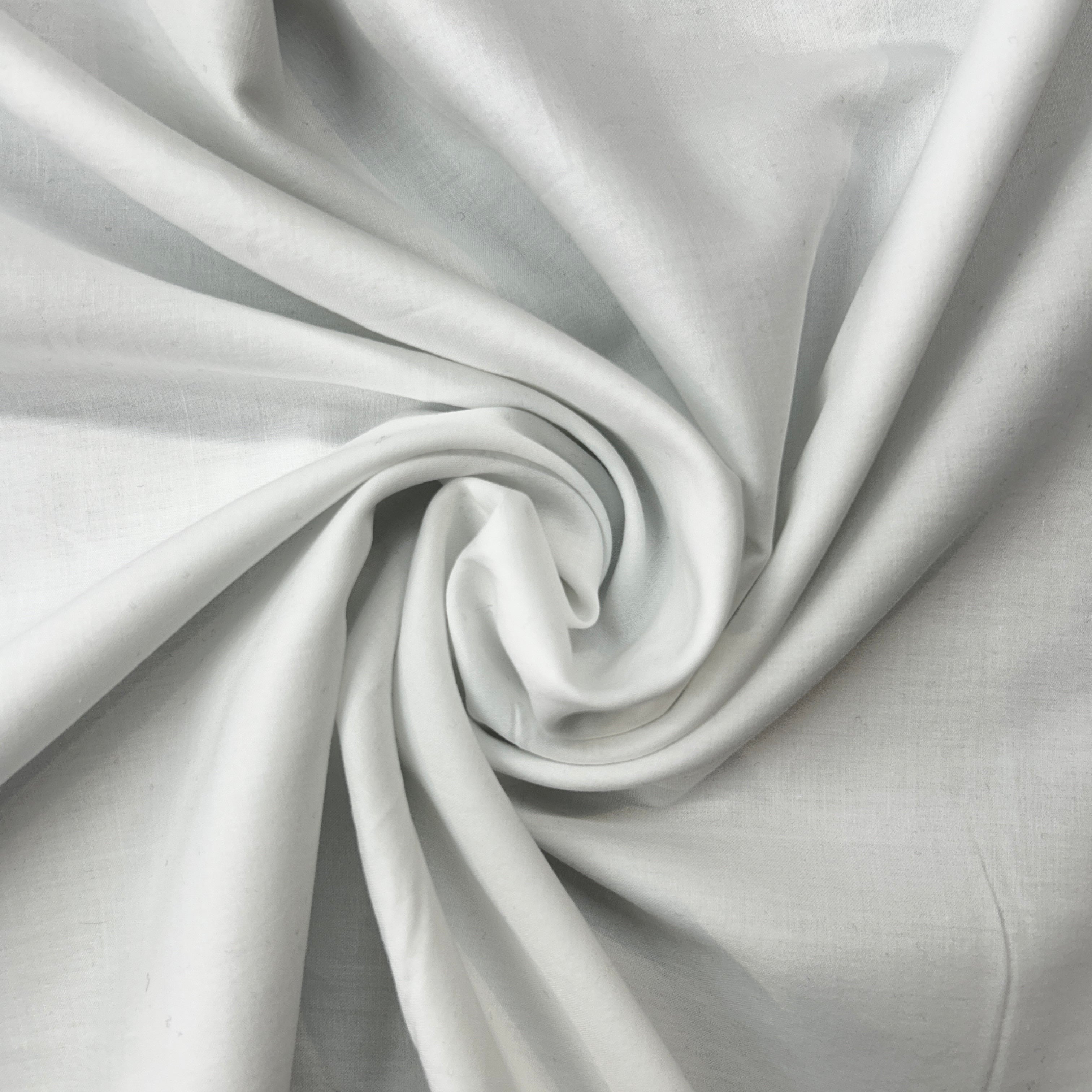 Close-up of white fabric with a swirl pattern