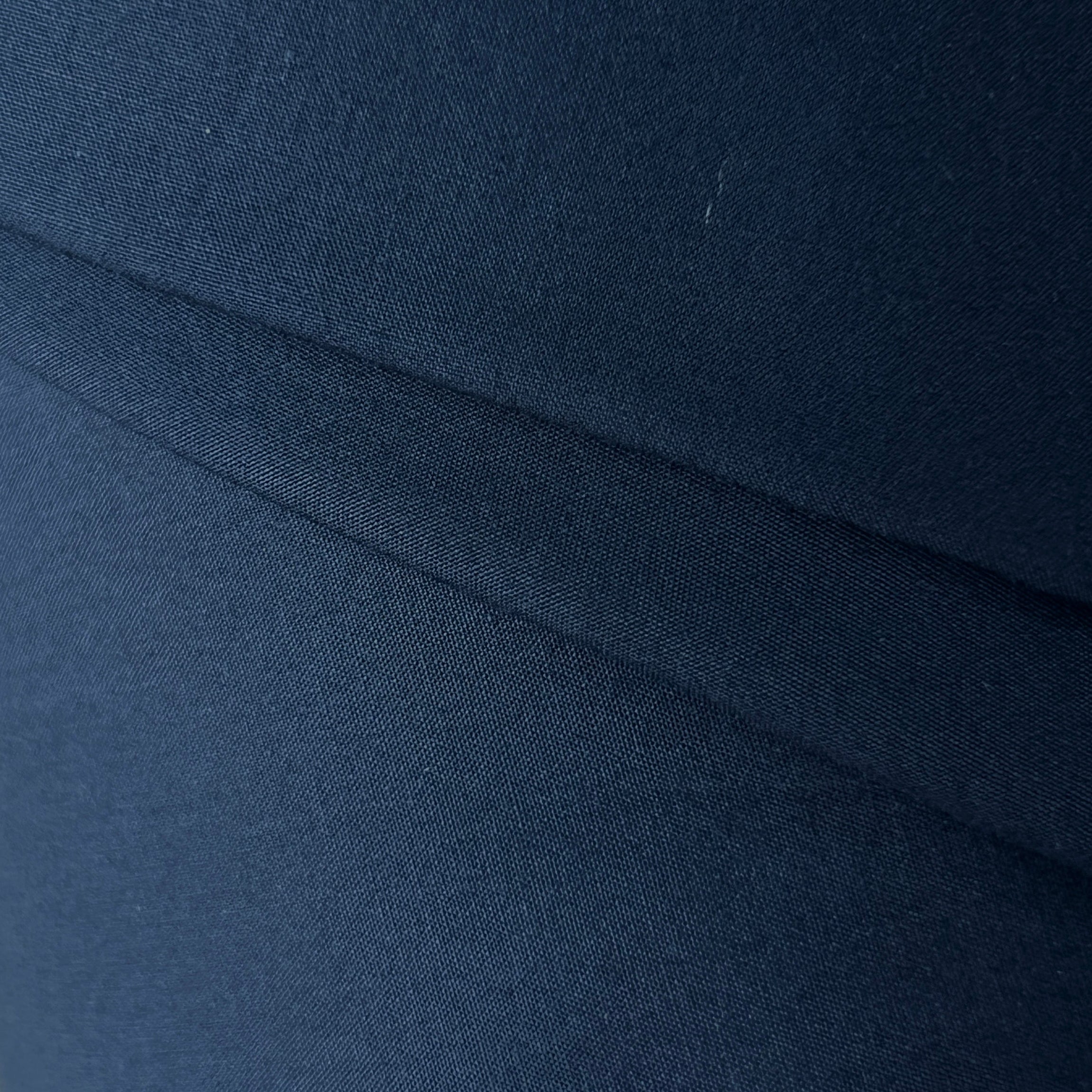 Close-up of dark blue fabric with a subtle pattern