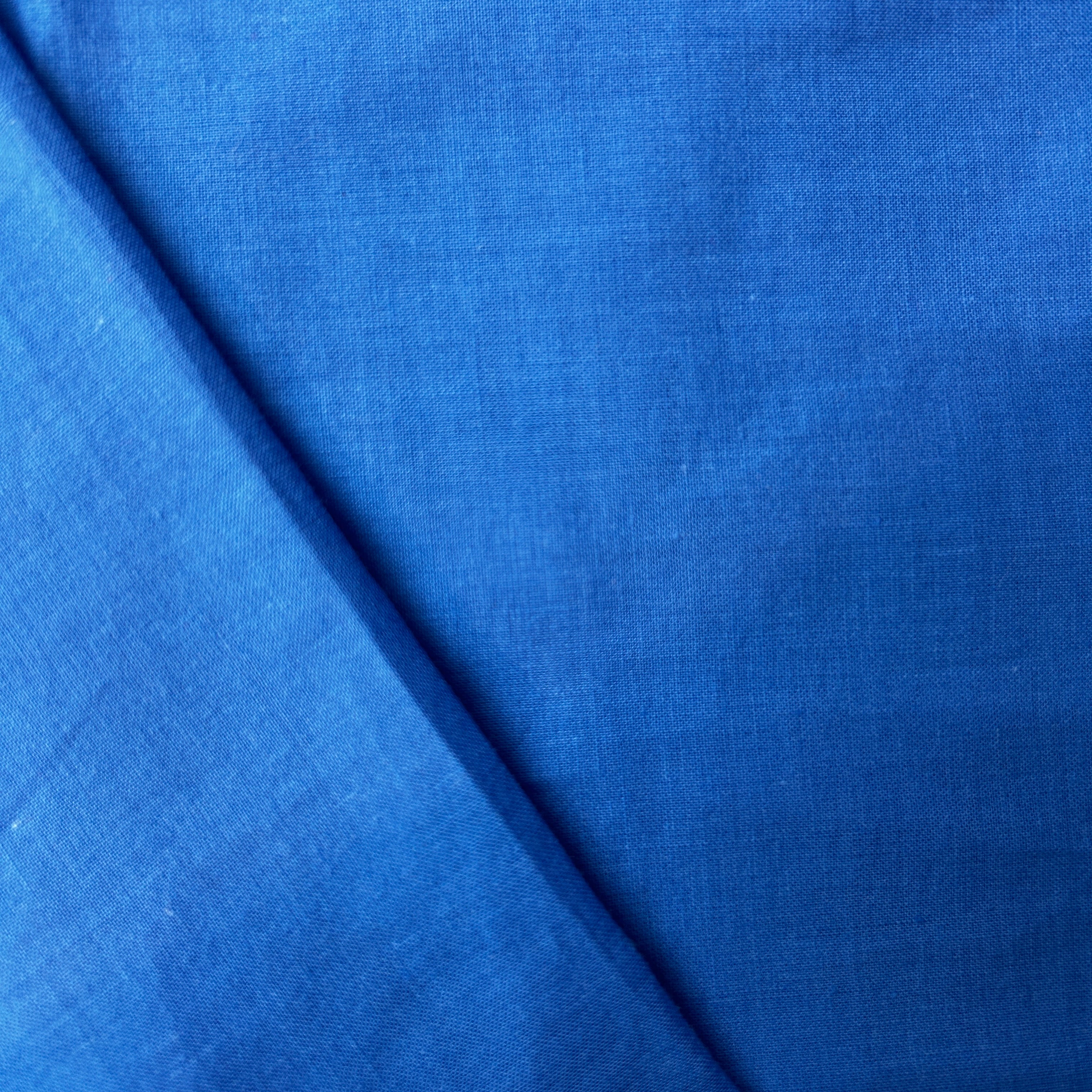 Close-up of blue fabric with a subtle texture