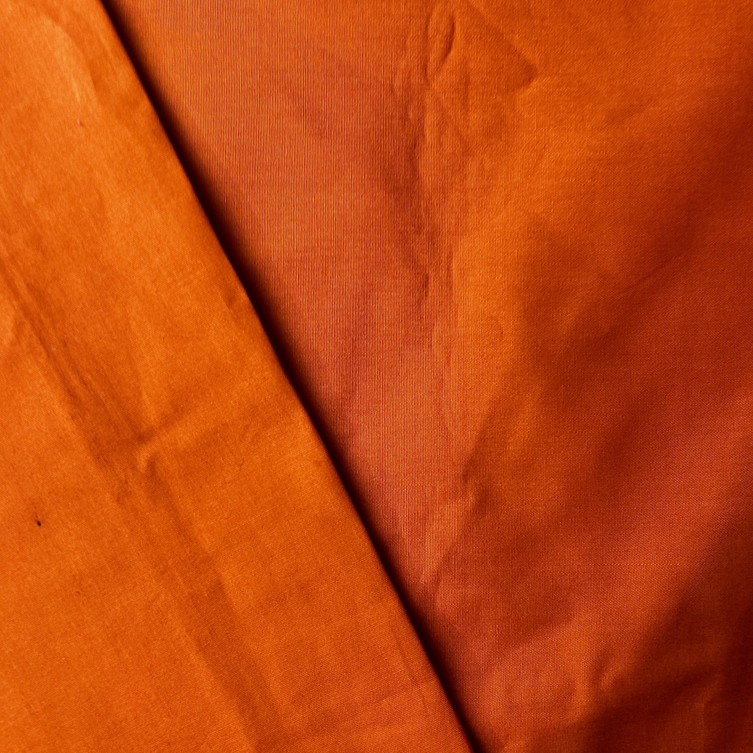Close-up of brown fabric with a visible crease