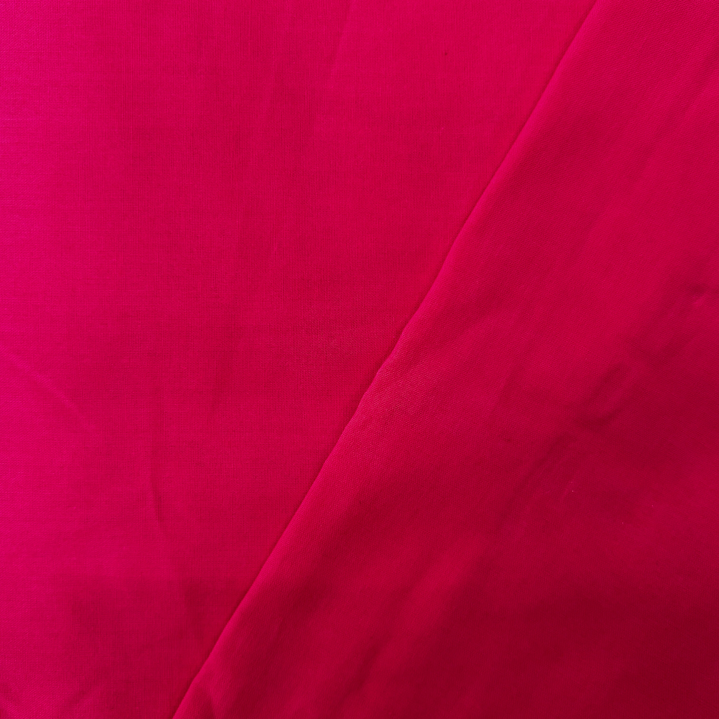 Close-up of bright pink fabric with a slight texture