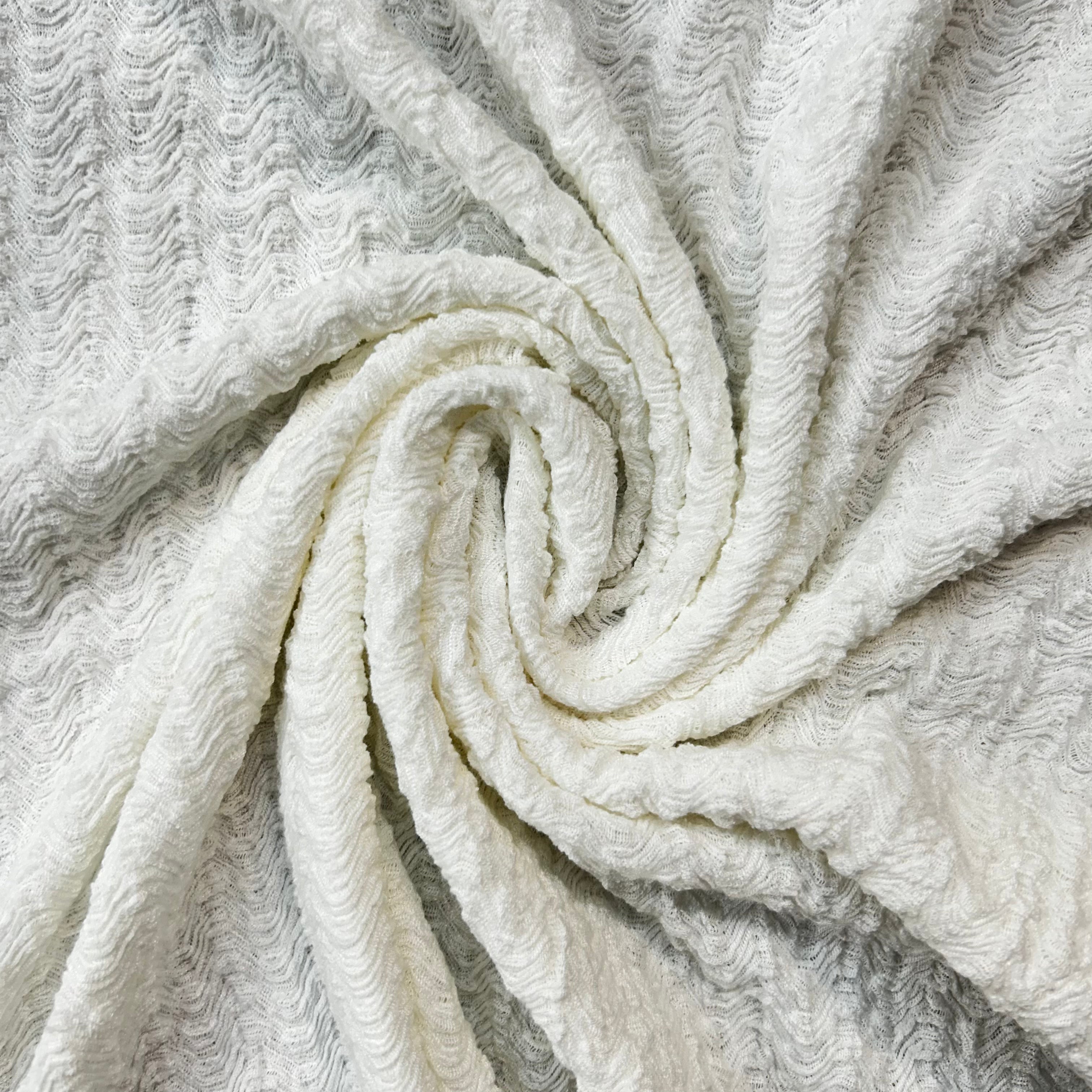 Close-up of a rolled-up white towel with textured surface