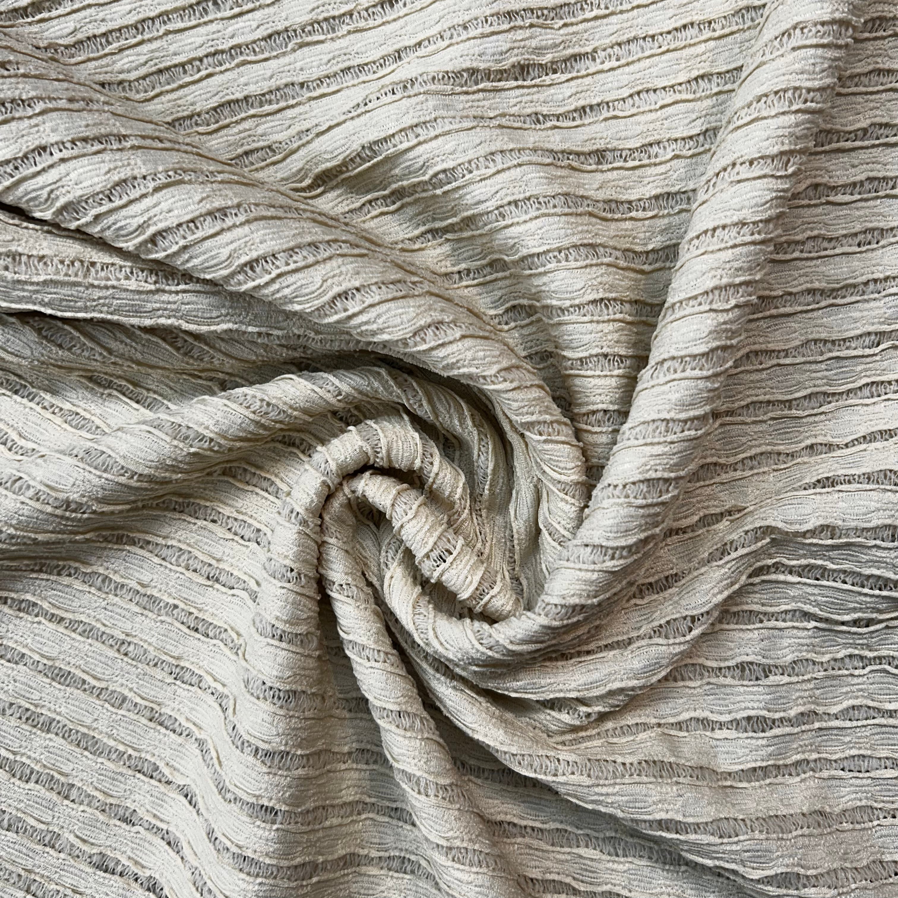Close-up of textured beige fabric with a crumpled appearance