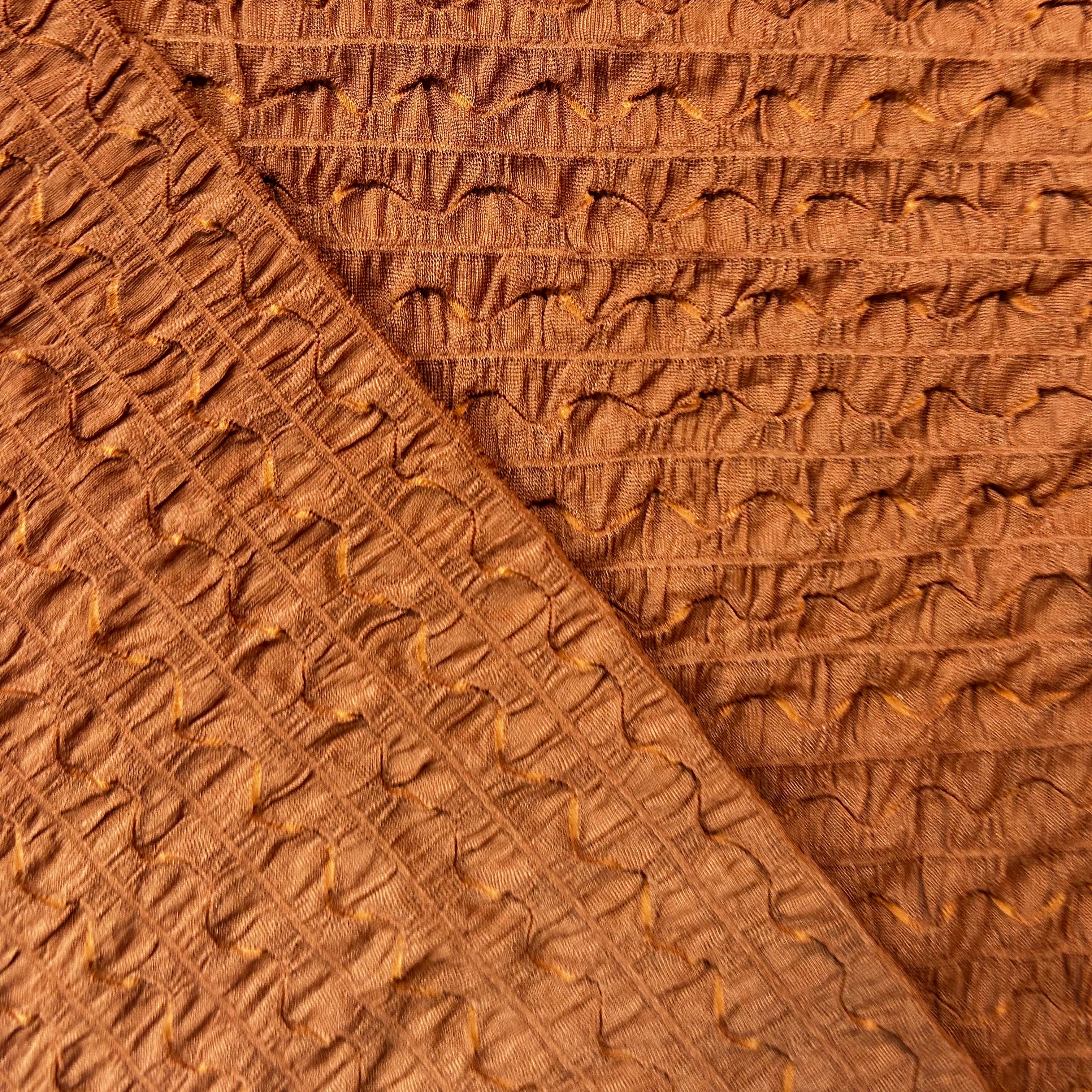 Close-up of brown textured fabric with a subtle pattern