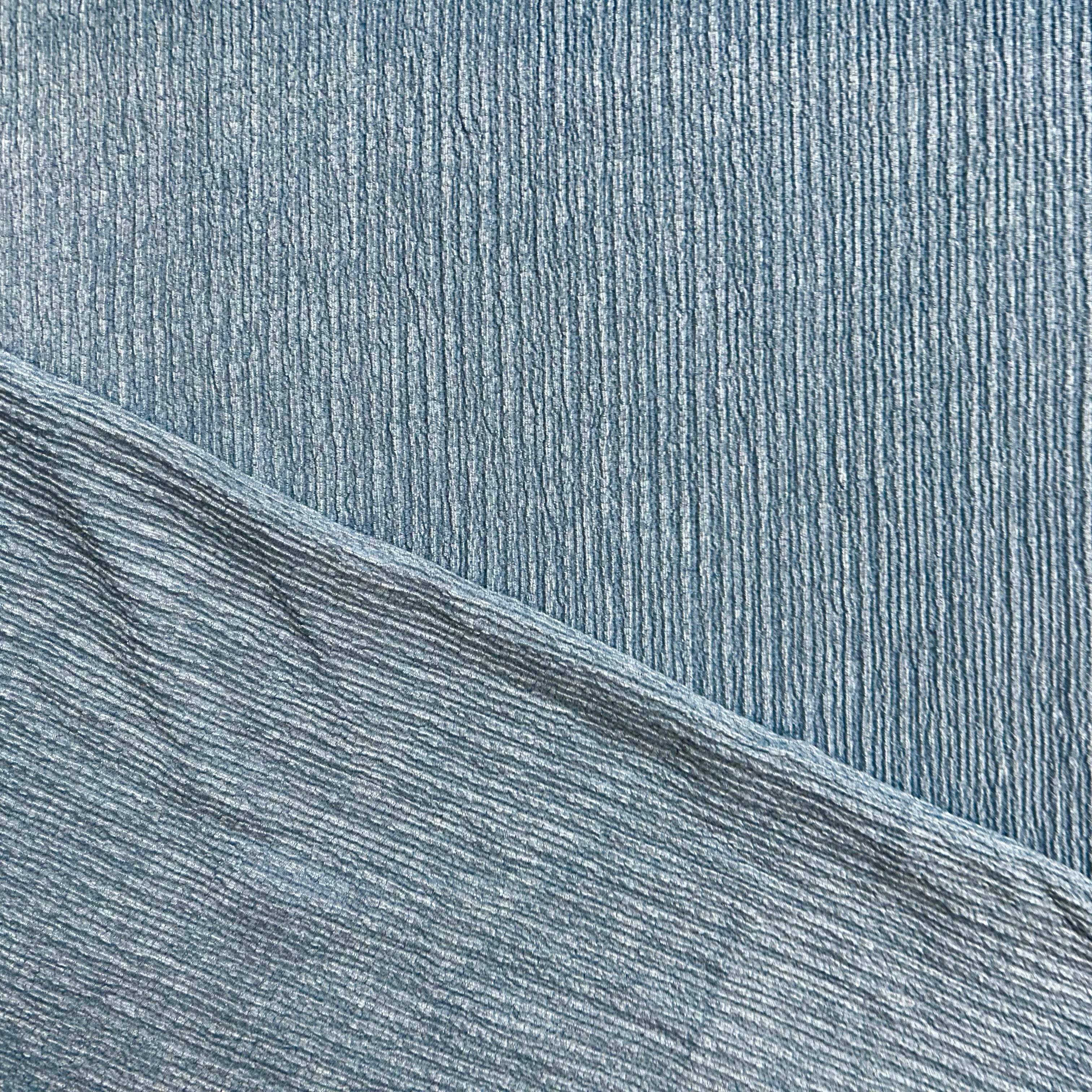 Close-up of textured blue fabric with a diagonal pattern