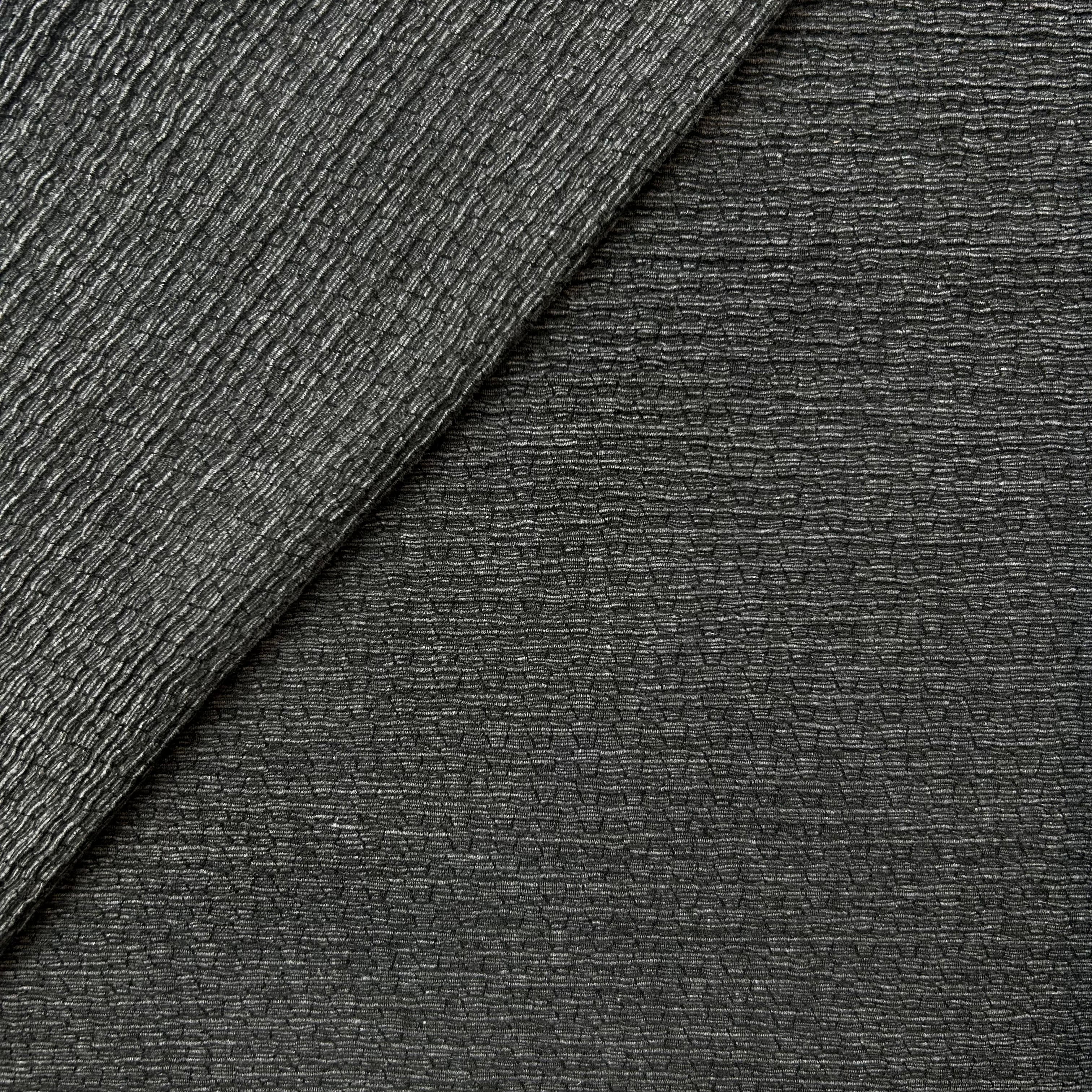Two different textures of gray fabric on a diagonal