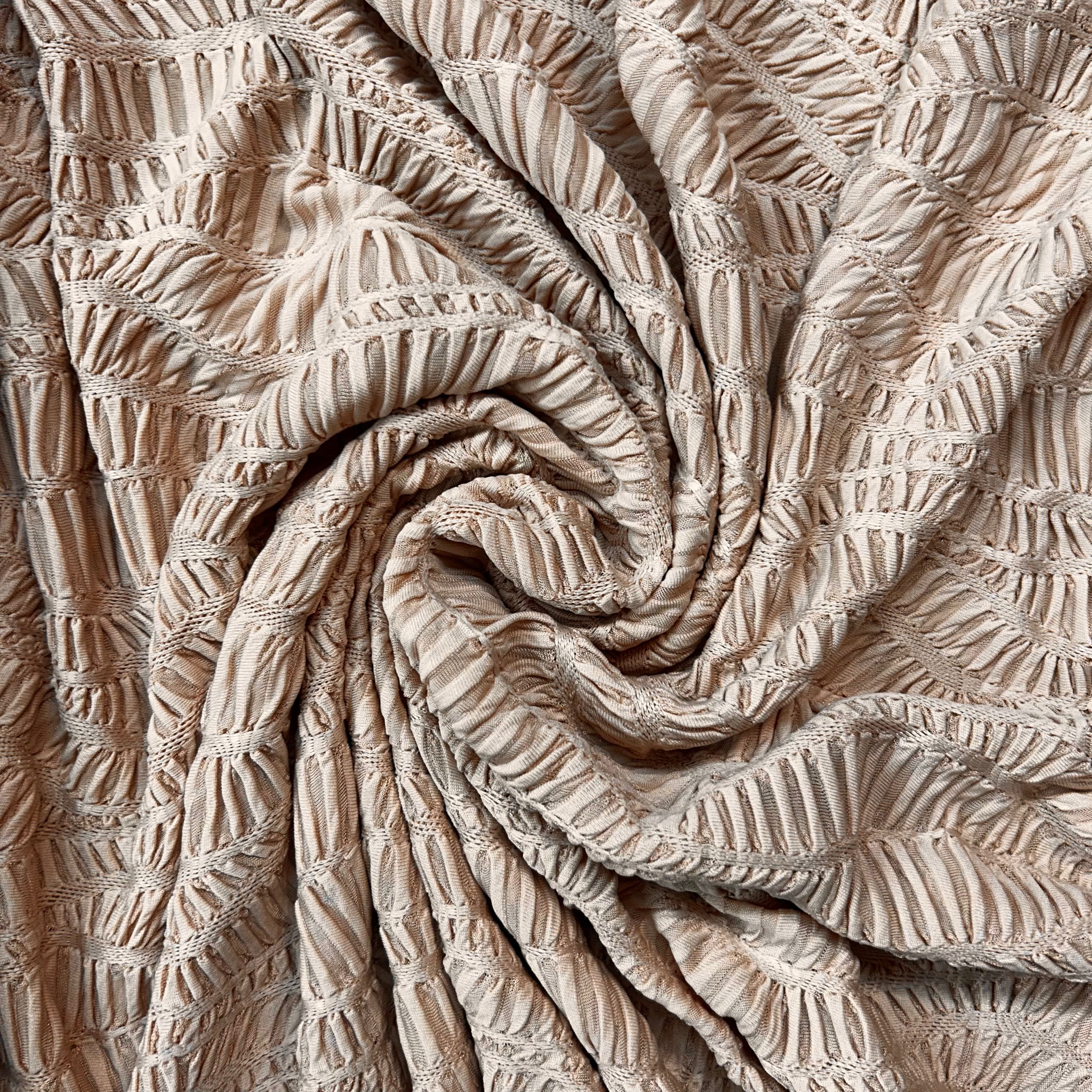 Close-up of textured beige fabric with a subtle pattern