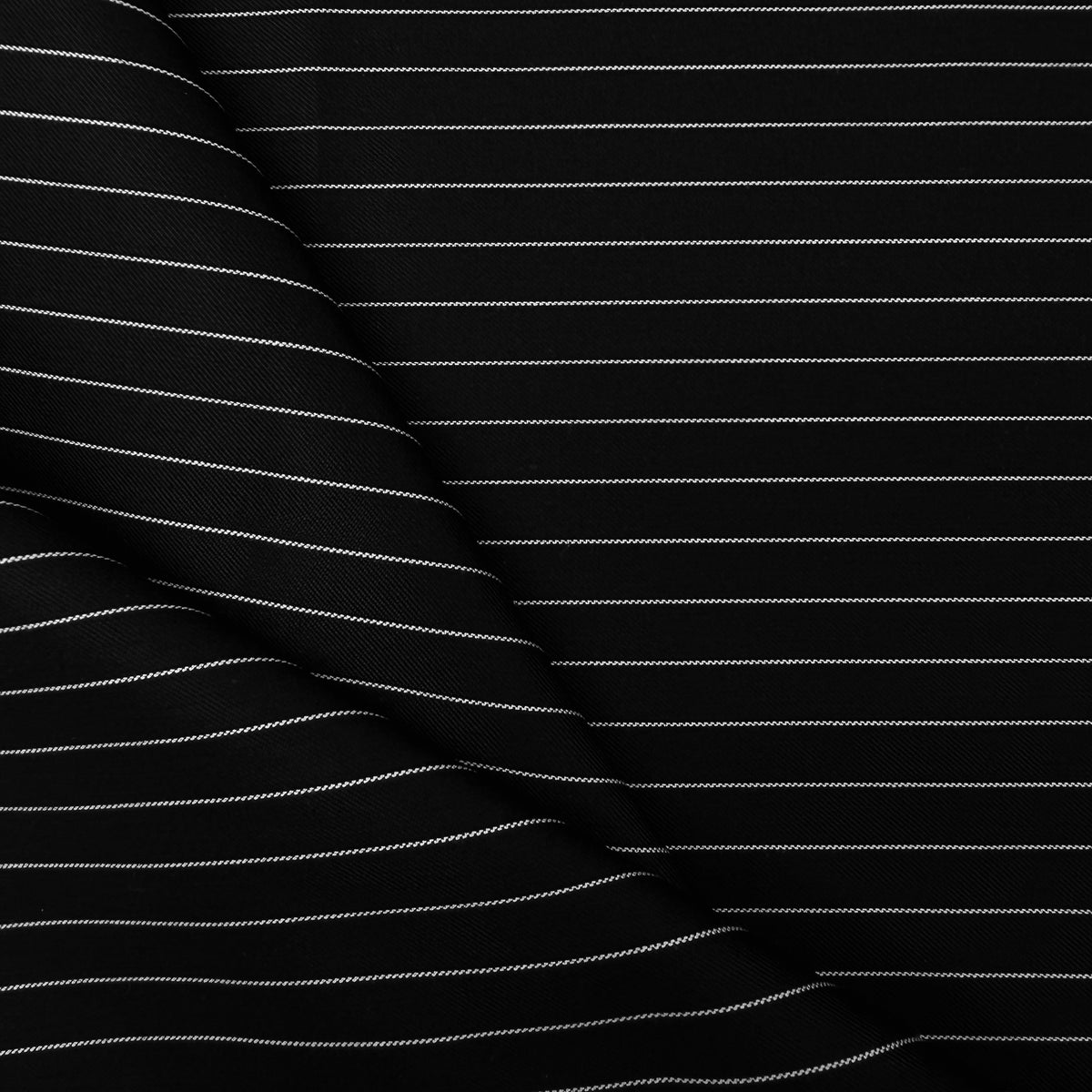 Black fabric with thin white pinstripes, shown in a close-up with a soft fold on the left side.