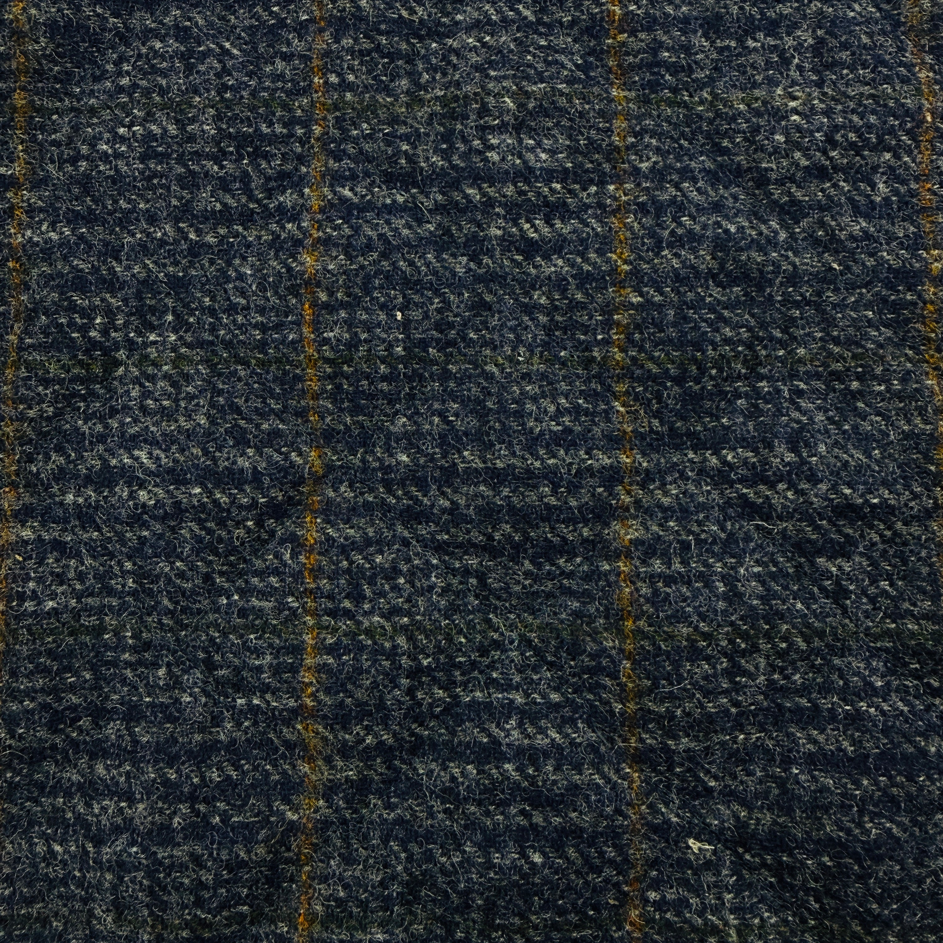 A close-up of dark navy blue textured fabric with a subtle woven pattern and thin vertical gold stripes.