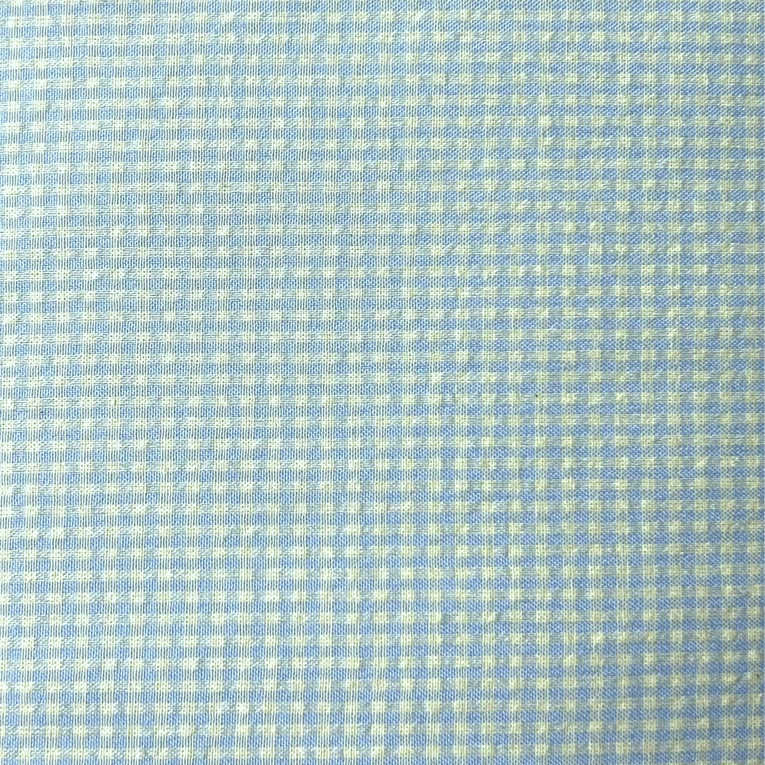 Close-up of a light blue fabric with a subtle pattern