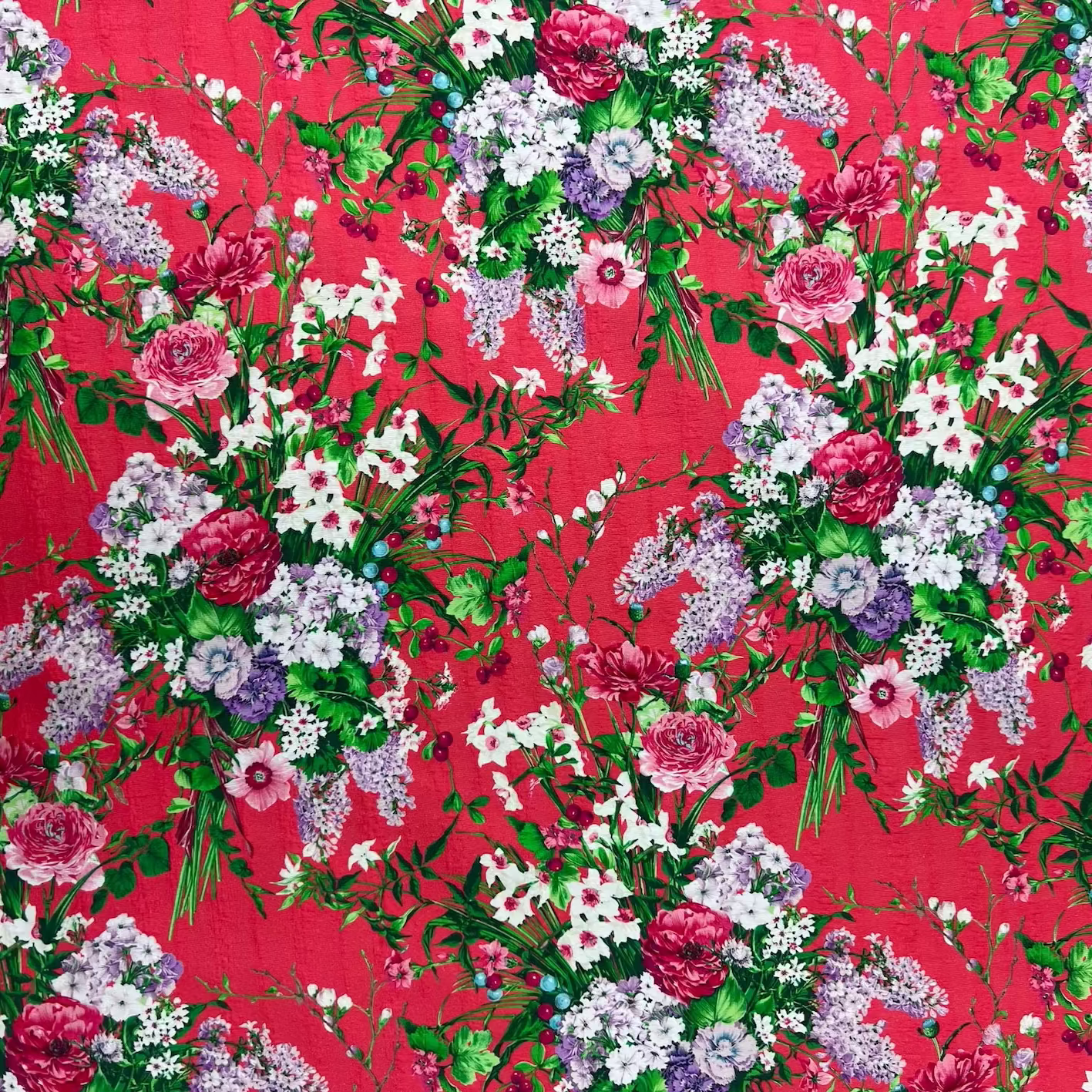 Floral pattern with pink, white, and purple flowers on a red background
