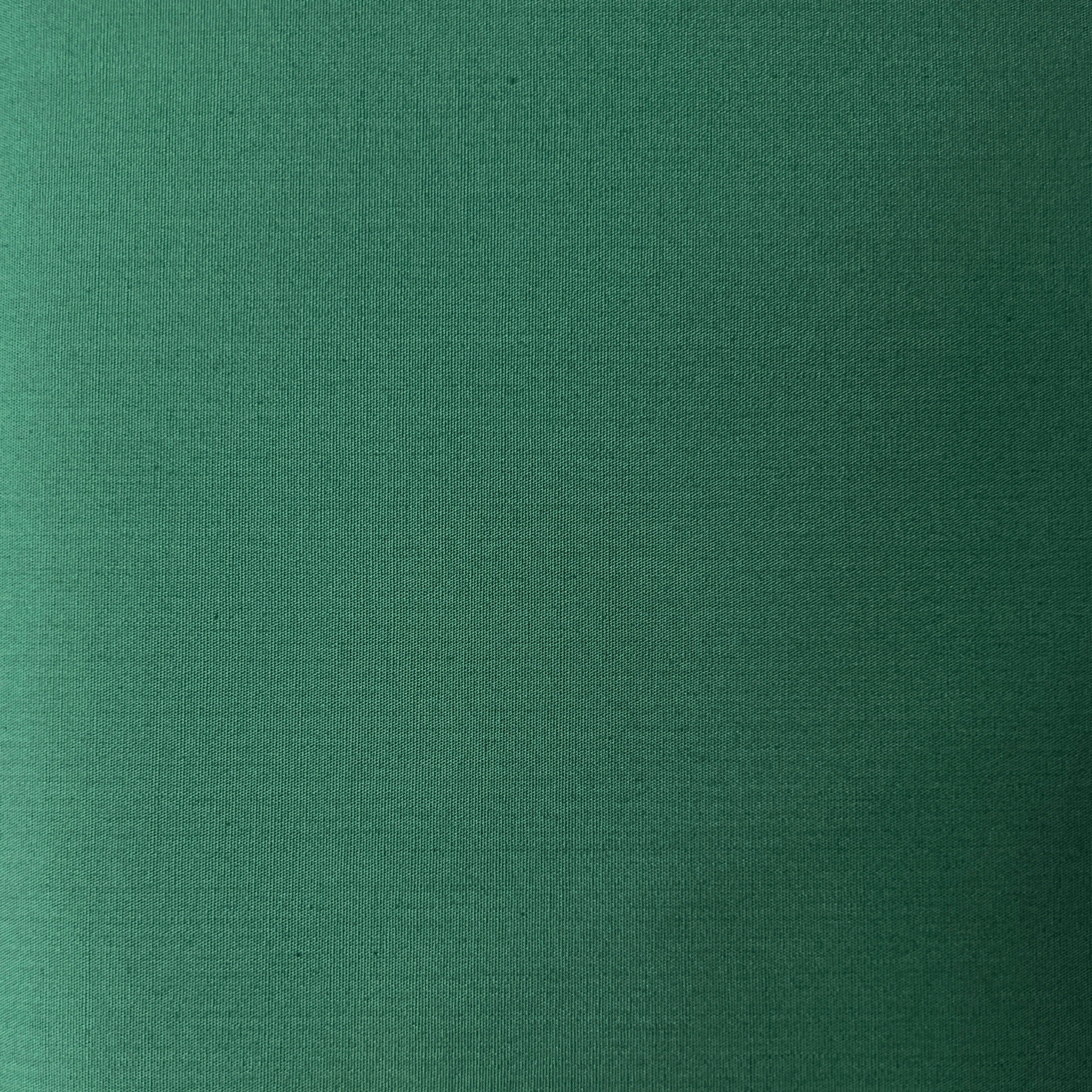 Green 100% cotton poplin fabric with a plain weave texture.
