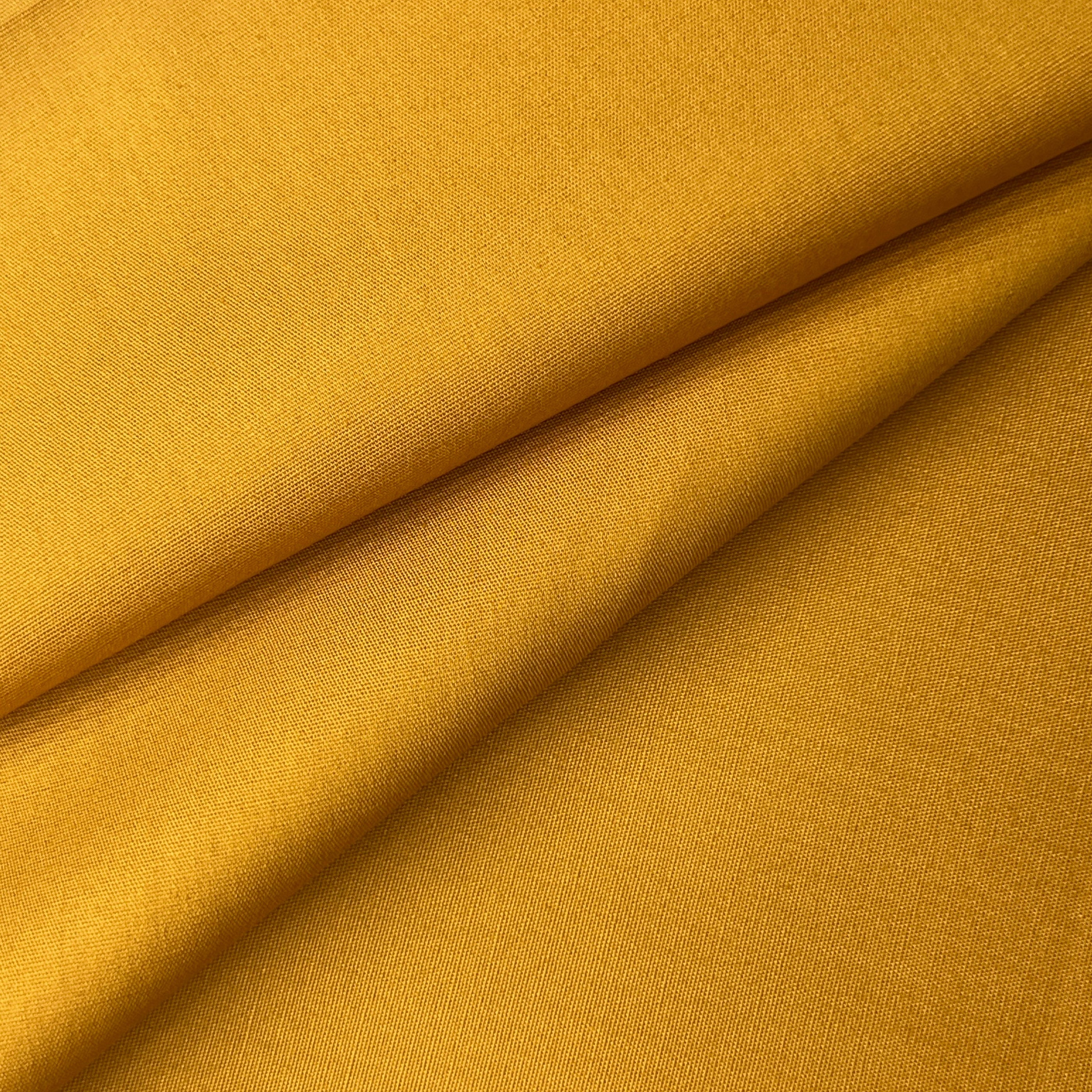 Yellow 100% cotton poplin fabric with a plain weave texture, folded to show depth.