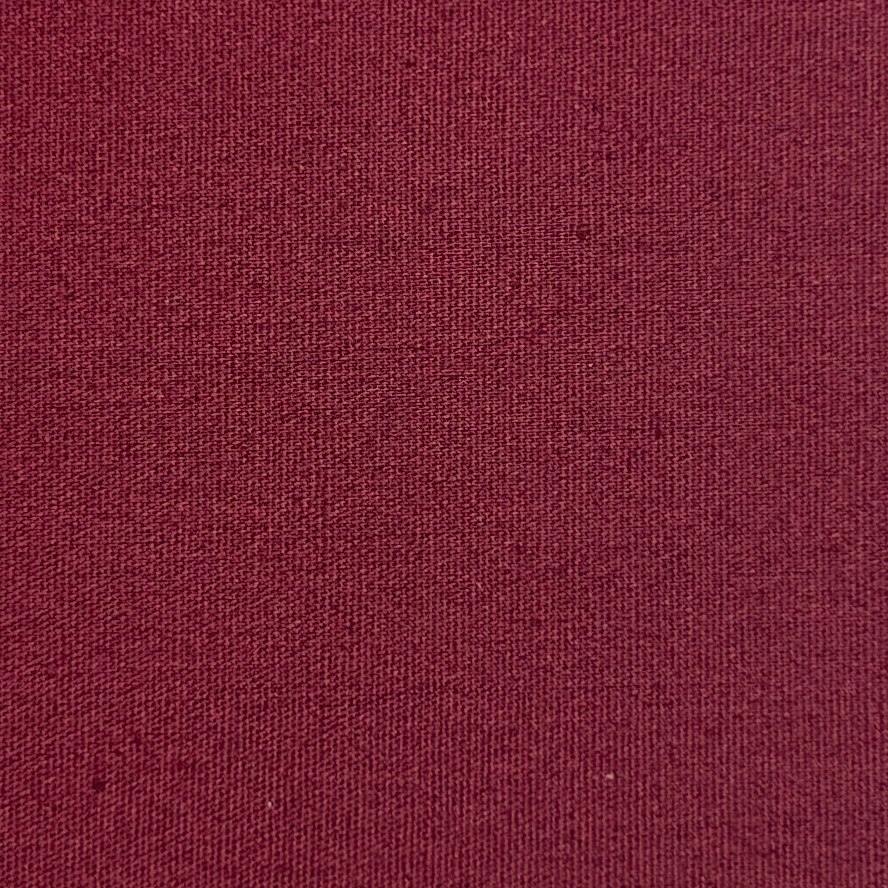 Close-up of a deep burgundy cotton poplin fabric with a fine, smooth plain weave texture.
