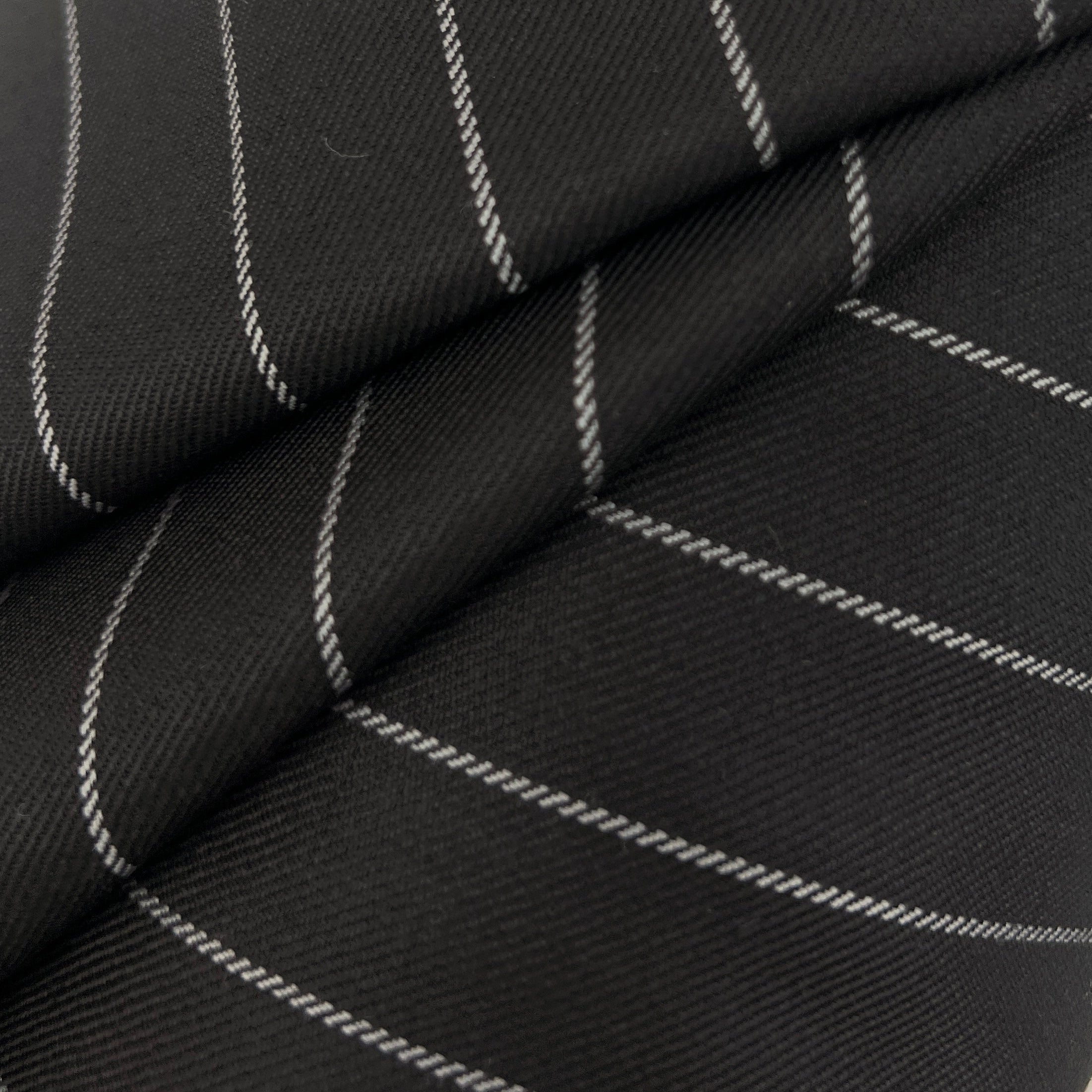 Black fabric with thin white pinstripes, shown in a close-up folded view to highlight the texture and pattern.